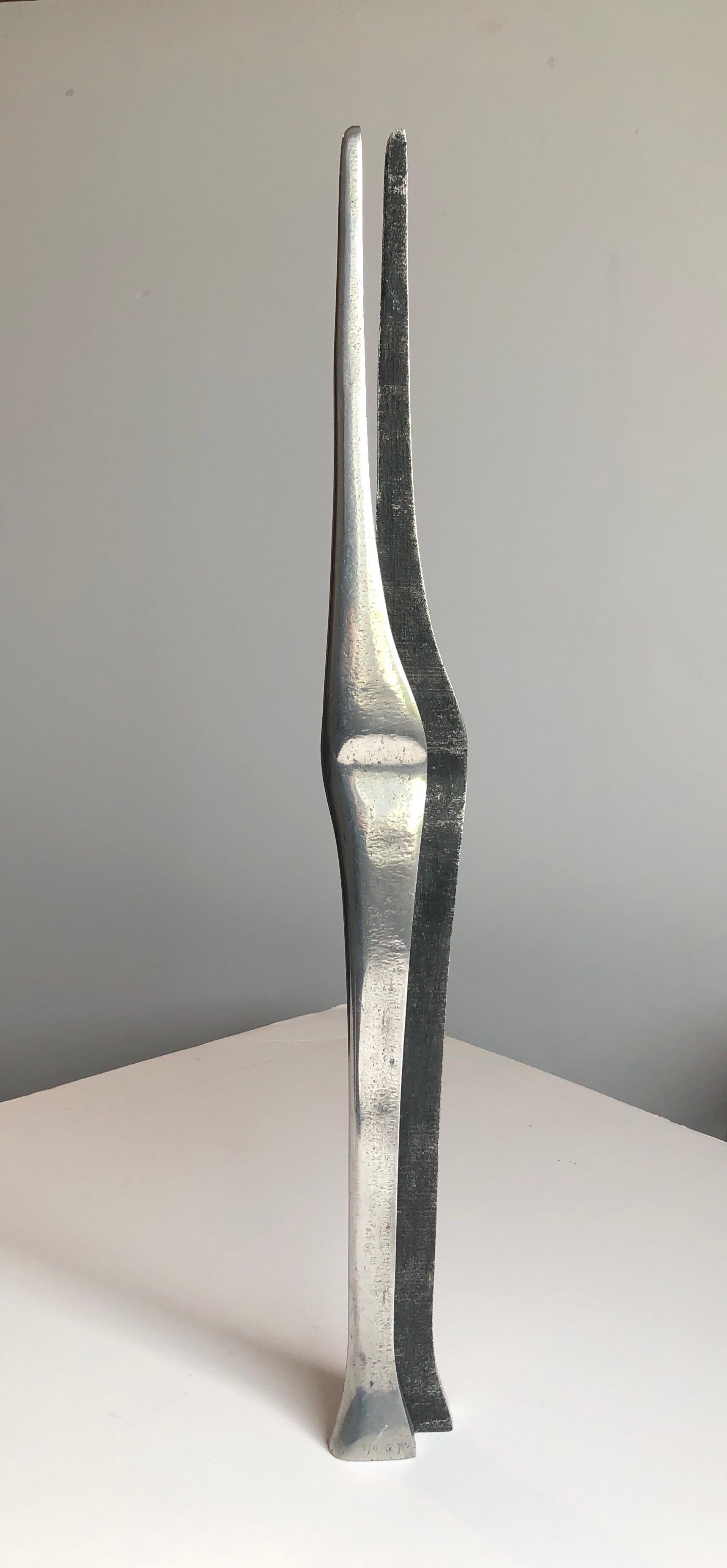 A suite of 2 sculptures. Lovers, man and woman nestled together. sleek minimalist mod sculpture.
polished finish on one side. not sure if theese are stell or aluminium. they are cast and signed in Hebrew with initials and numbered 9/9. It is 2 parts