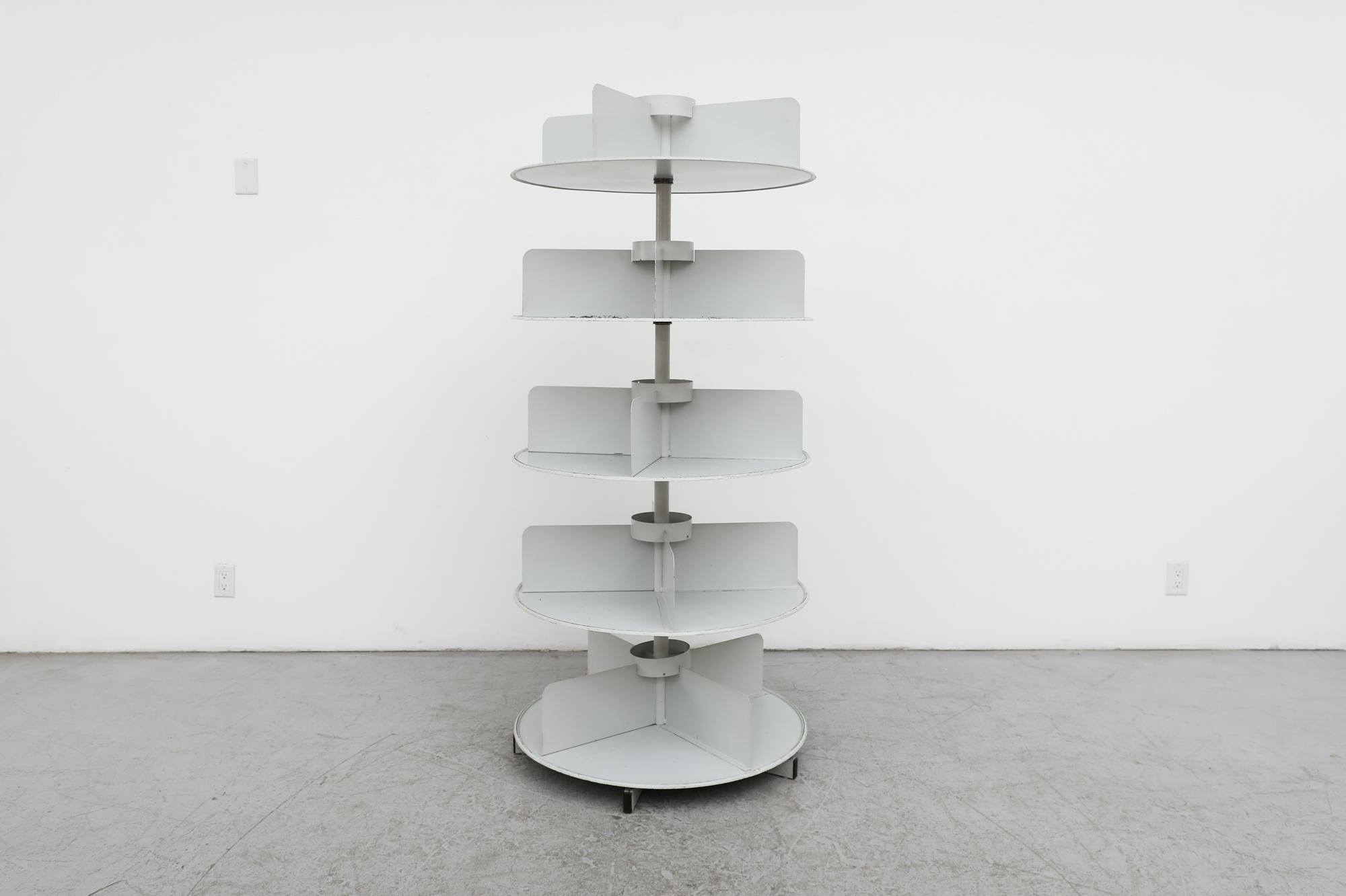 1960's Ahrend de Cirkel large industrial grey enameled metal bookshelf with rotating shelves. Each circular shelf is divided into four sections. Founded in 1896, Ahrend initially focused on small goods with the first office furniture (which was to