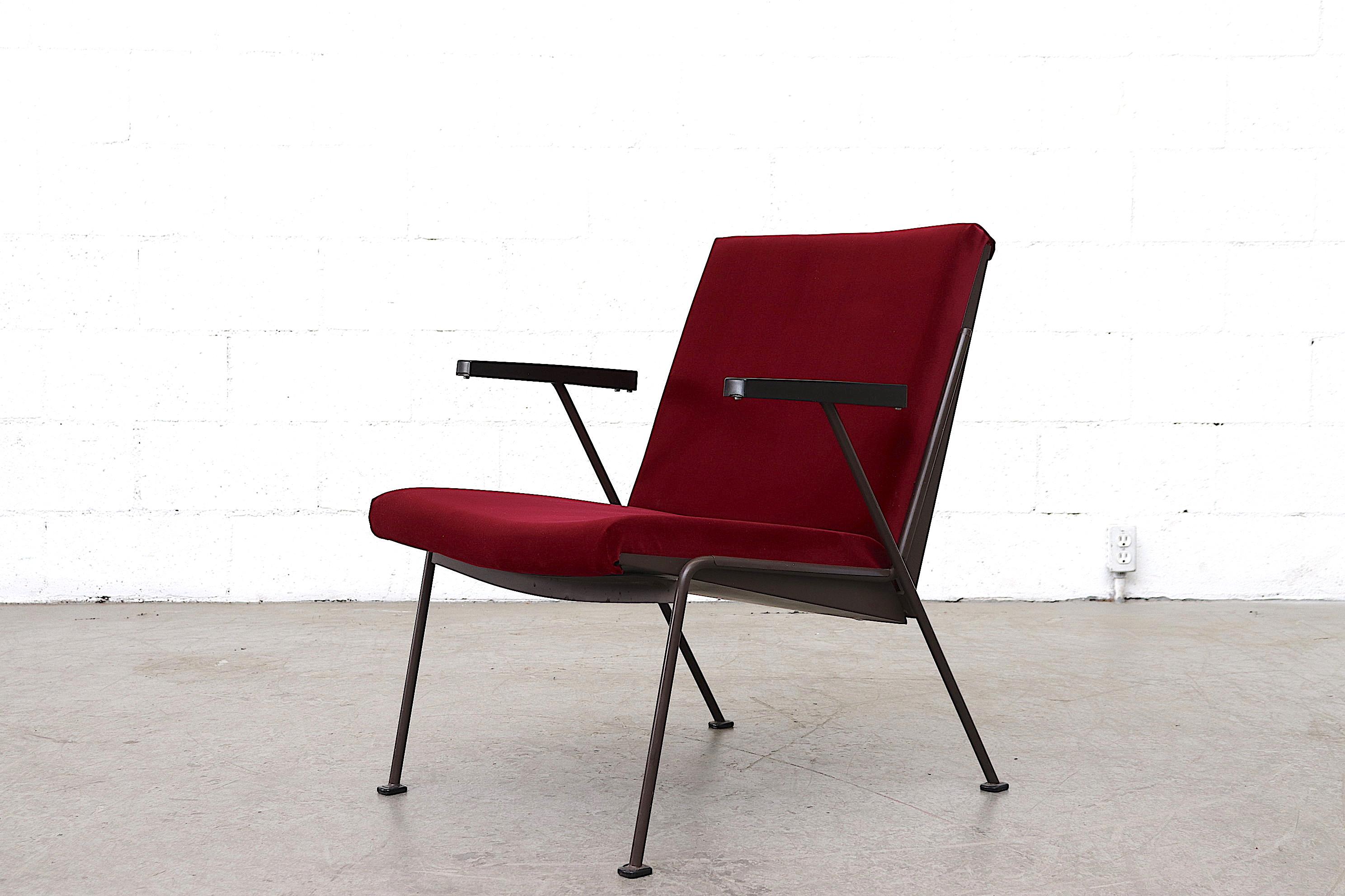 Wim Rietveld newly upholstered garnet velvet lounge chair for Ahrend de Cirkel with original chocolate brown enameled metal frame and bakelite armrests. Frame in original condition with some wear.