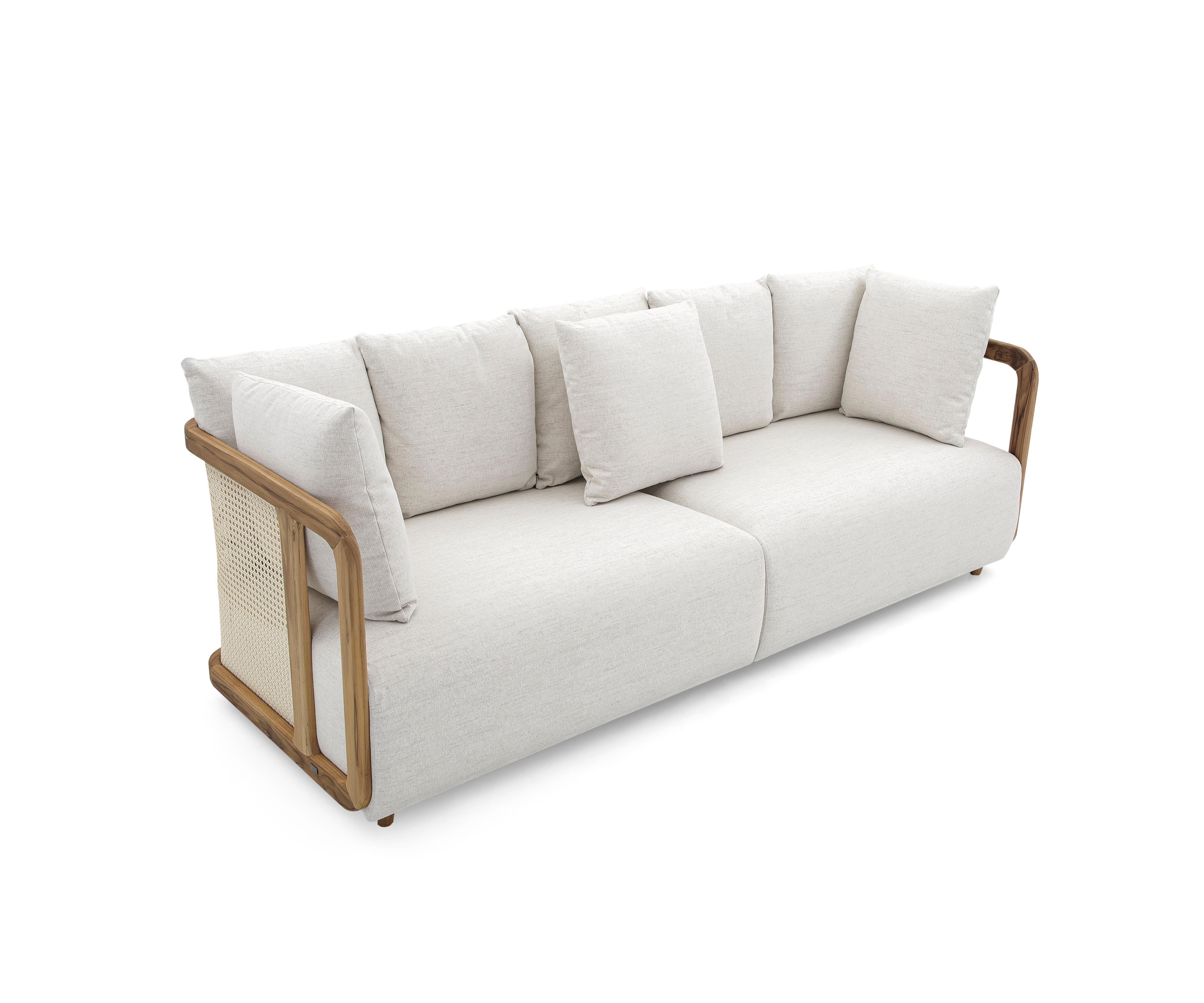 The Aiby sofa is the perfect combination of natural straw in the back and the armrests, a light beige beautiful and soft fabric seat and back pillows, and wood legs in a teak Uultis finish to match this modern contemporary design. The backrest
