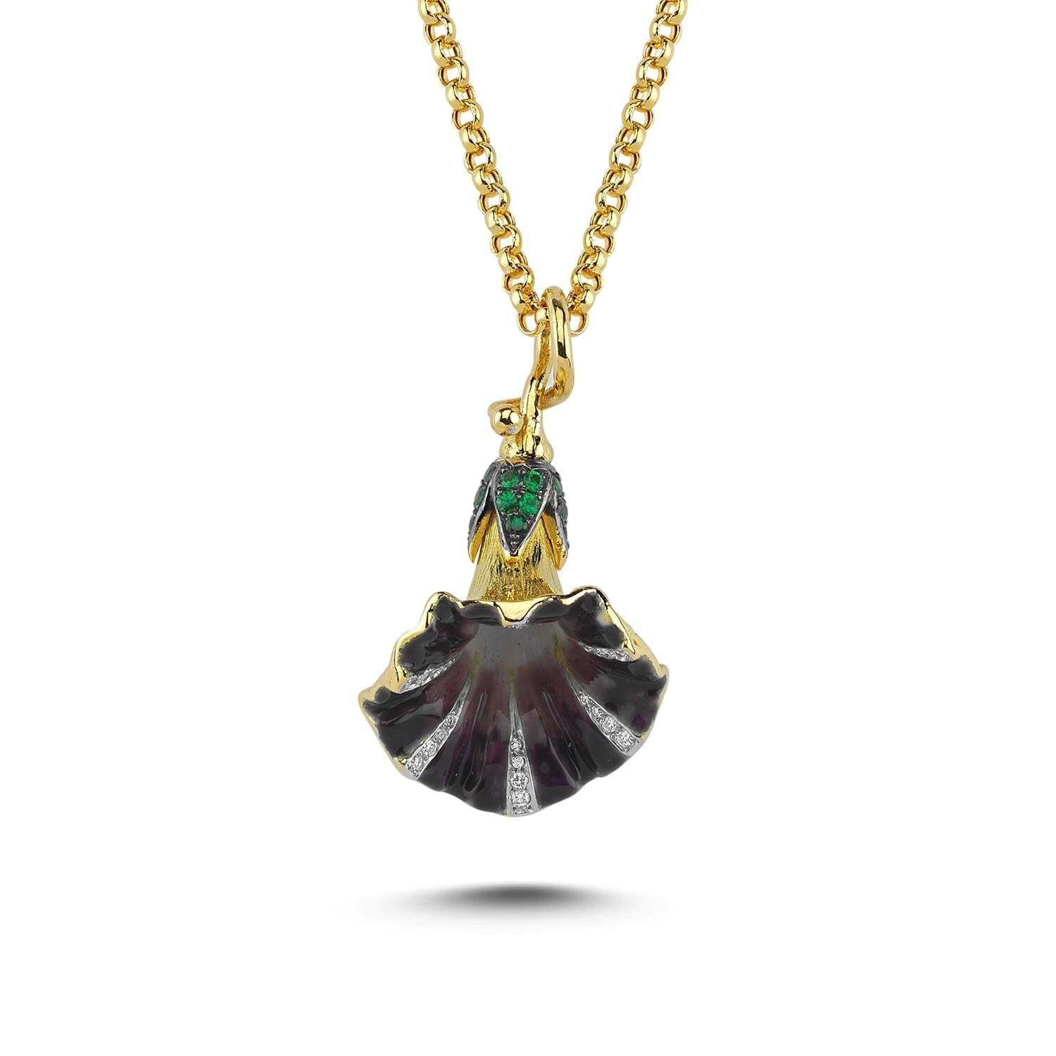 
The Violet Convolvulus Pendant is a humble yet fine example of high craftsmanship, hand carved in lost wax, set in 18k yellow gold with 0,15ct diamonds and 0,32ct green garnets completed with gradient vitreous enamel. 18k yellow gold chain is