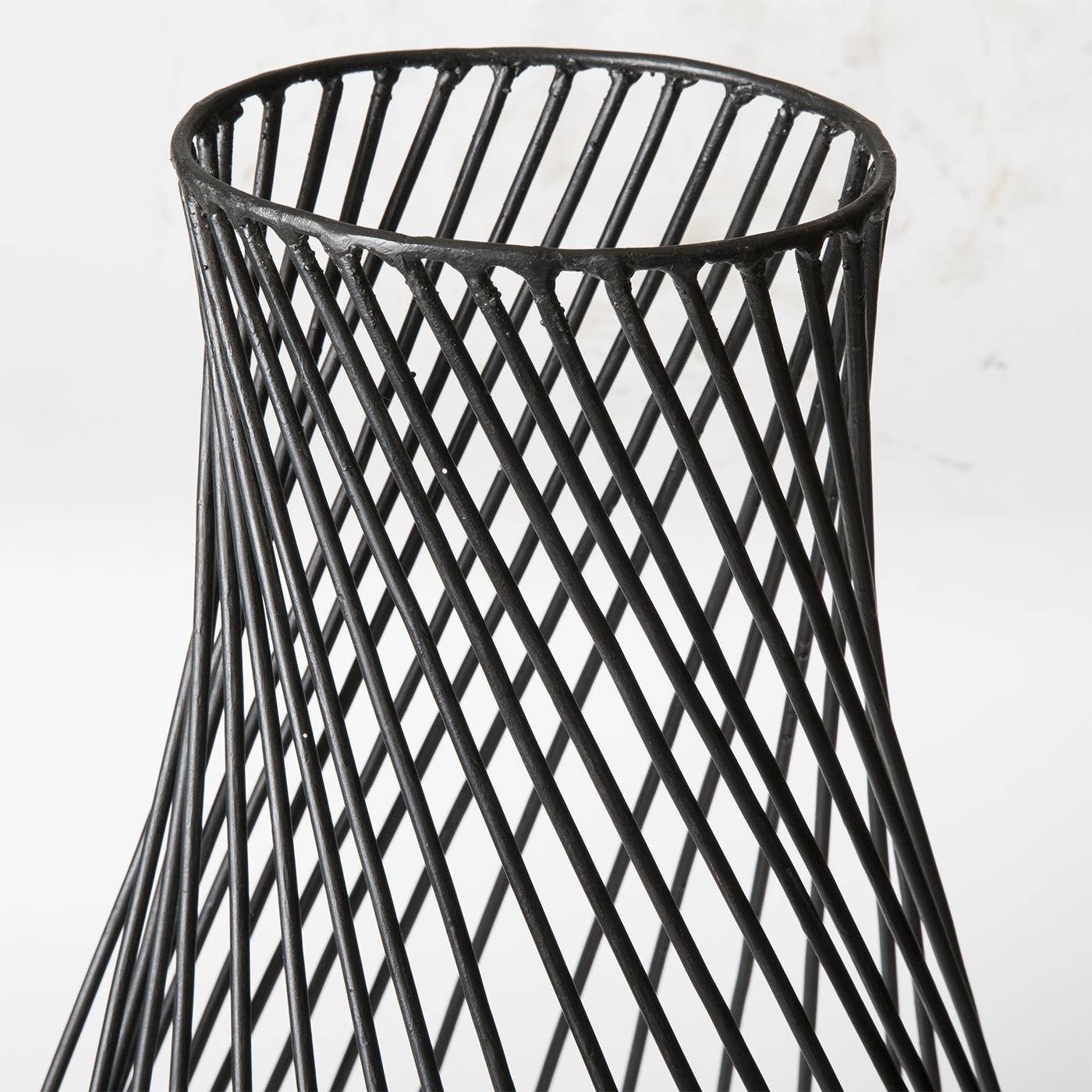 This is a tall sculptural vase of tempered iron wire designed and handcrafted by Milan-based artisan Antonino Sciortino. The shapely form is painted in black, lending it vivid definition. Product dimensions may vary slightly due to the artistic