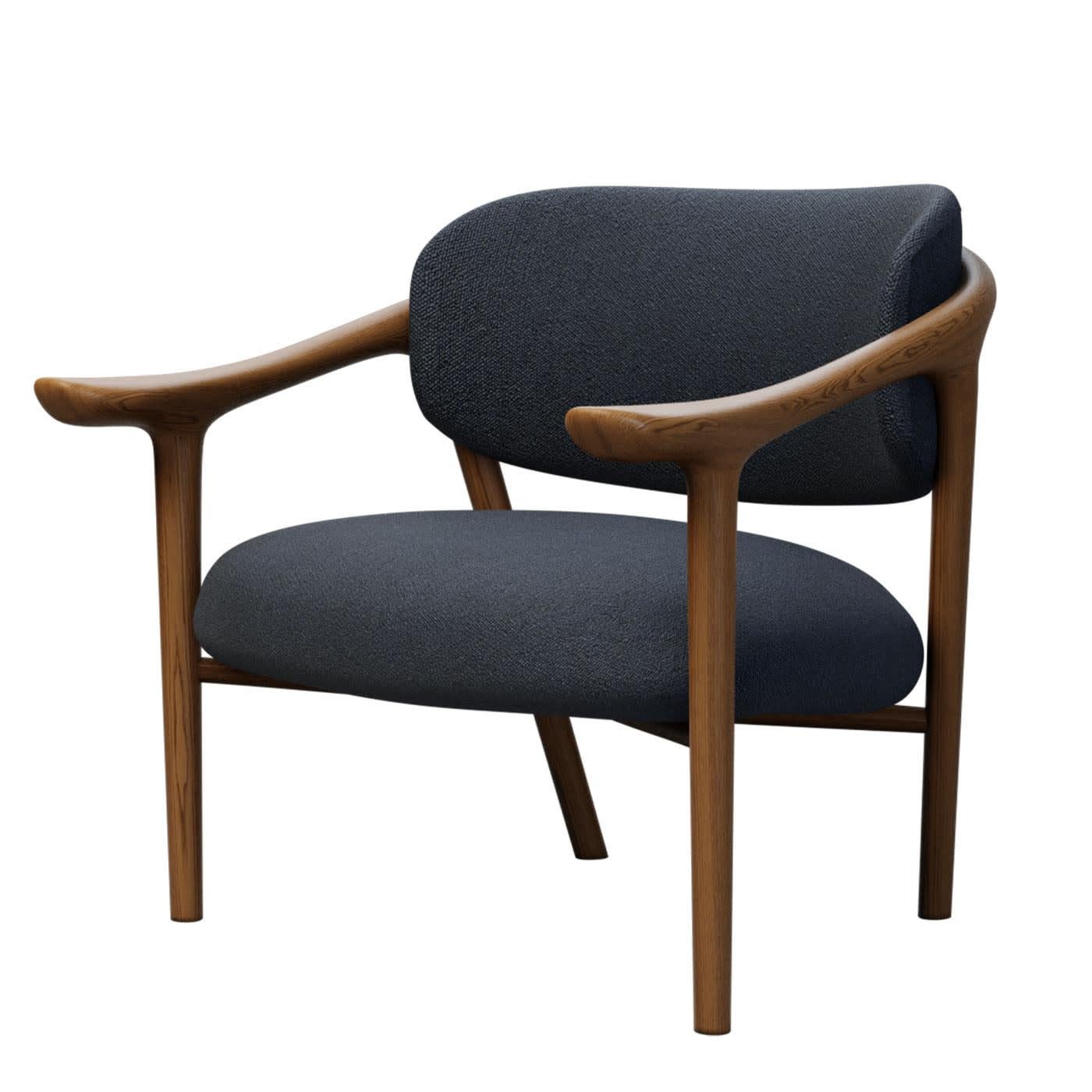 Elegant et épuré, ce fauteuil met en valeur un design moderne d'une valeur intemporelle. Fabriqué à la main en bois de frêne, il est doté d'une assise et d'un dossier doucement paddés, tous deux recouverts de tissu. Conçue par Libero Rutilo pour