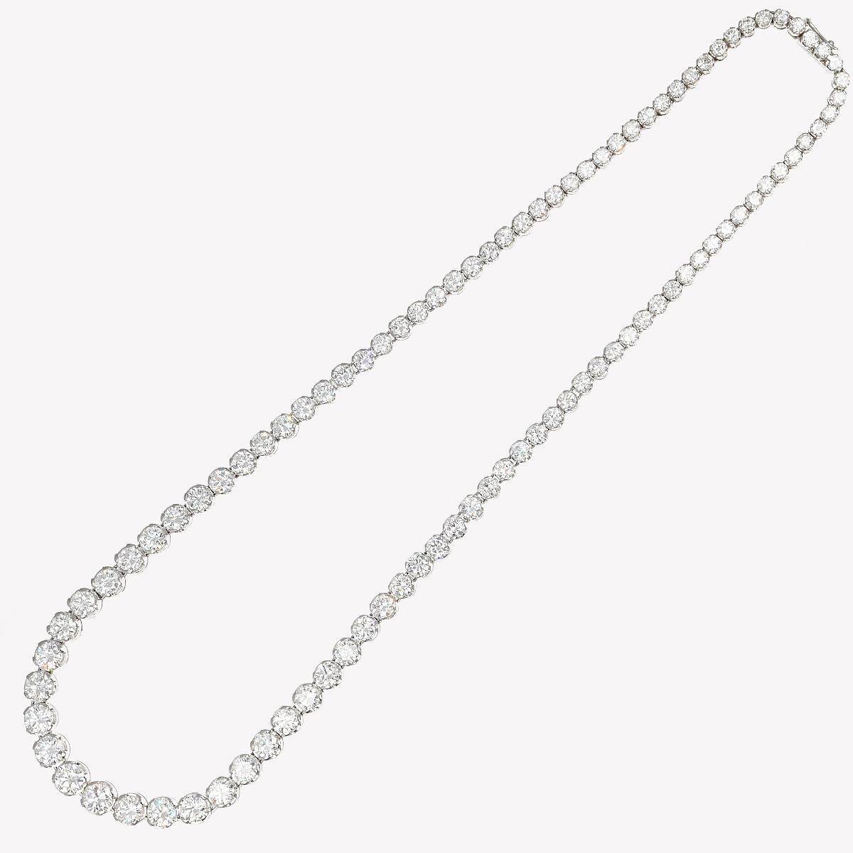 A symphony of light and luxury unveils itself in this graduated tennis necklace, a jewel that embodies the pinnacle of understated elegance and timeless allure. Each carefully chosen diamond sparkles with an intensity that captures the gaze and