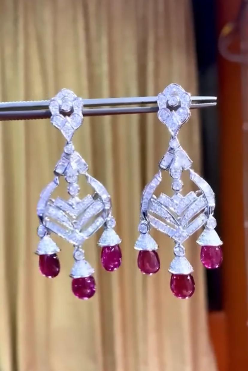 An sparkling pair of earrings with red rubellite and bright diamonds, adorning with elegance . Design is so divine , refined, a very piece of art. Crafted with precision, a sight to behold , beauty untold , in shades of crimson fire, 
A treasure to