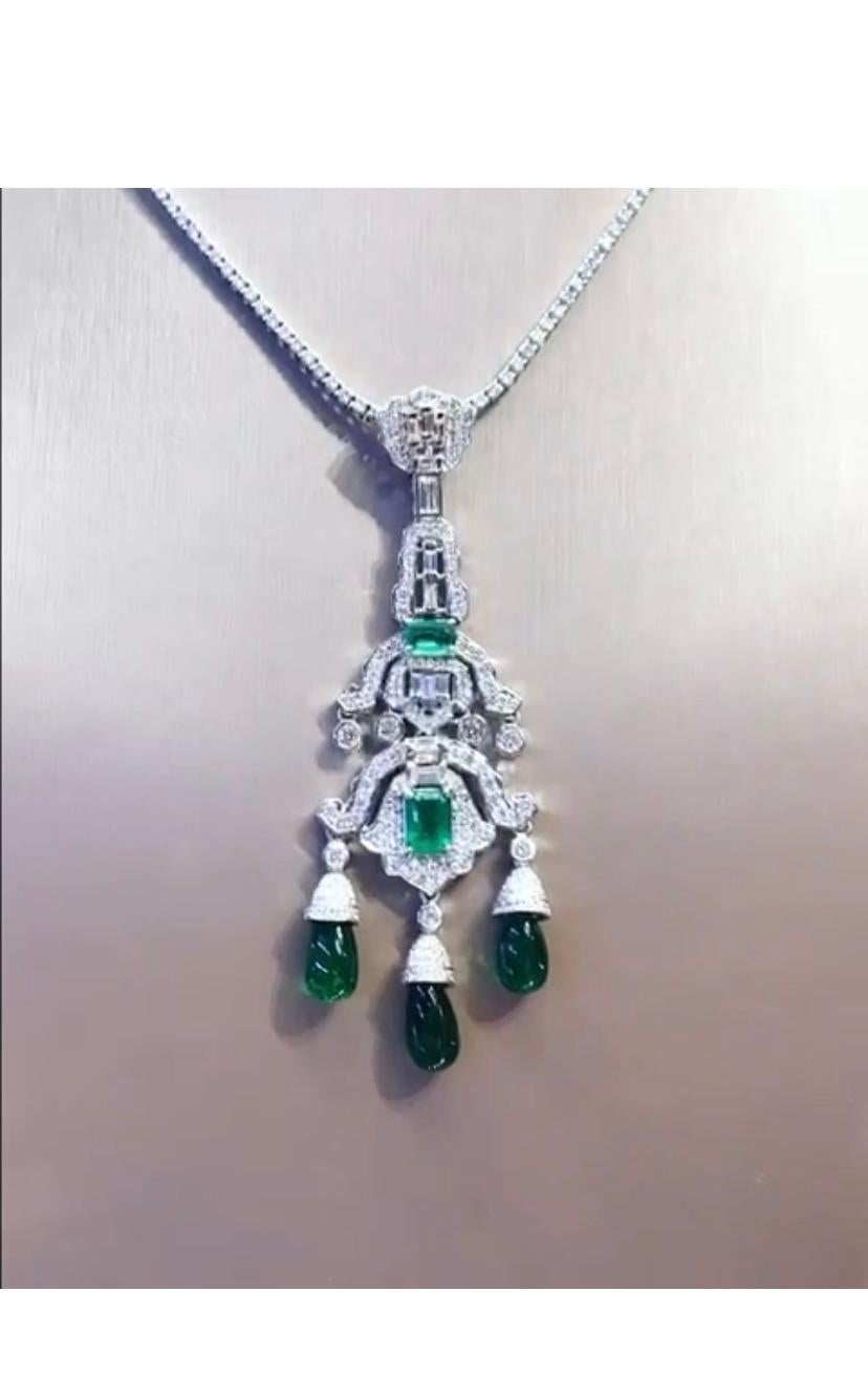 An exquisite Art Deco design for this beautiful pendant in 18k gold with three drop cut natural Zambia emeralds ct 12,45, and two  natural Zambia emeralds ct 2,24, and round and baguettes cut diamonds ct 2,33 F/VS. 
Handmade by artisan
