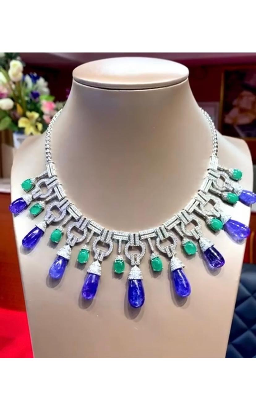 An exclusive ART DECÓ design, 
 so extraordinary and glamour style, a very piece of goldsmith art . 
Necklace come in 18k gold with 9 pieces of natural tanzanites 166.42 carats, cabochon cut
fine quality, 10 pieces of natural Colombian emeralds