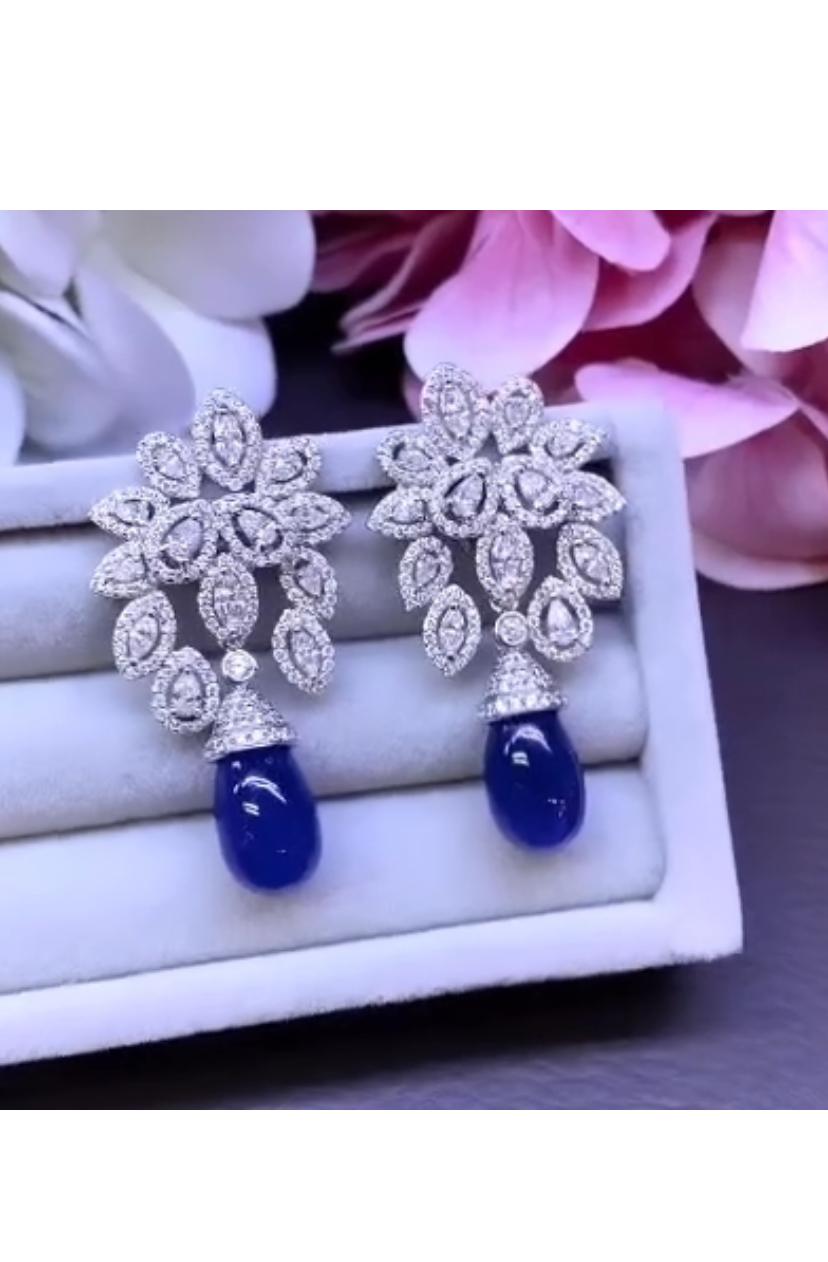 This stunning pair of earrings features two exquisite Tanzanites , exuding a sense of elegance and sophistication.
The vibrant tanzanites are beautifully complemented by sparkling diamonds , creating a truly special and unique piece that is sure to
