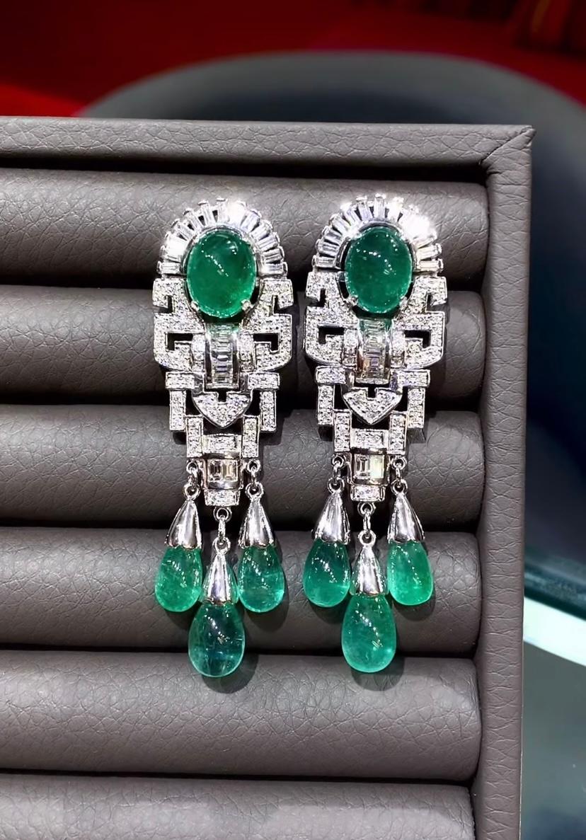 A pair of exquisite earrings boast a refined Art Deco design that exude timeless elegance.
The emeralds with their green hue, captivate the eye with their vibrant brilliance. Nestled amongst the emeralds are glistening diamonds, which add a touch of