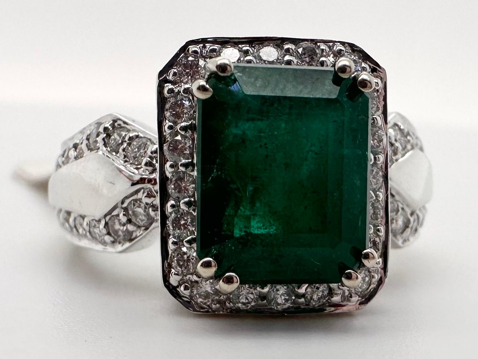 Rare stunning Zambian emerald diamond ring in 14KT white gold, certificate from AIG. Ring is size 7 and can be re-sized. The diamond weight is 0.77ct, the emerald is 2.94ct with moderately included clarity and green color. The diamonds are VS-SI