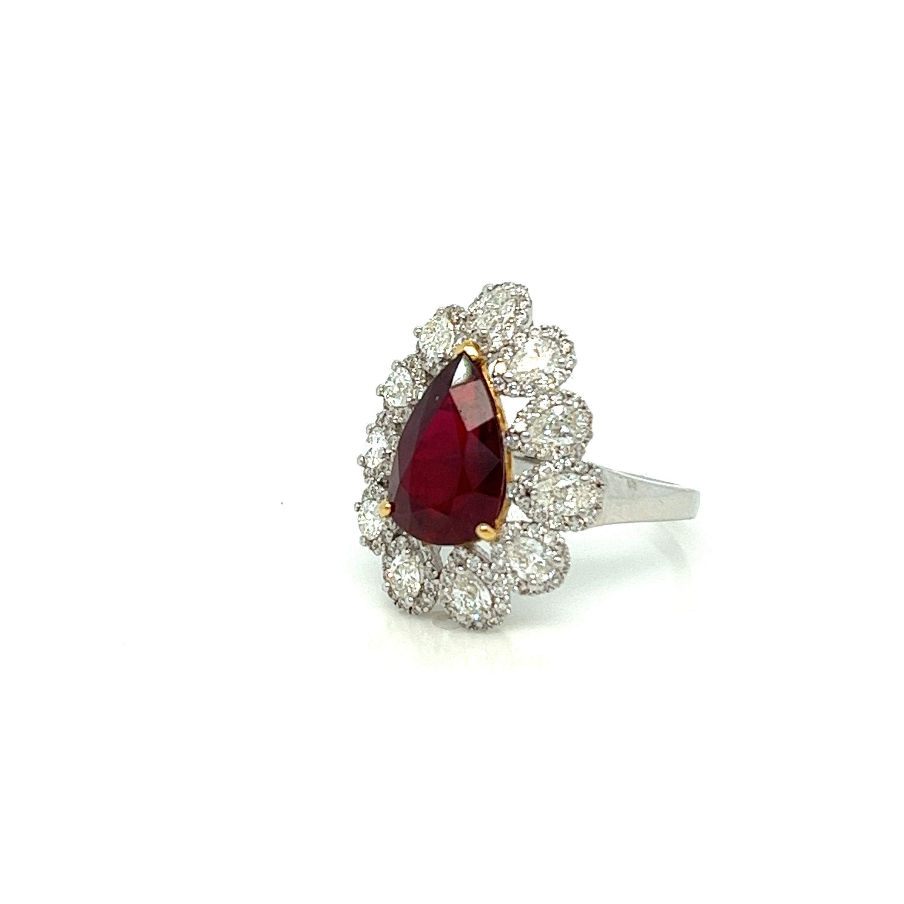 A spectacular cocktail ring, centering on the most delicious pear shape ruby center! It covers the perfect amount of finger real estate we love to see! She’s surrounded by bold and bright pear shape diamonds with an added halo around each stone. The