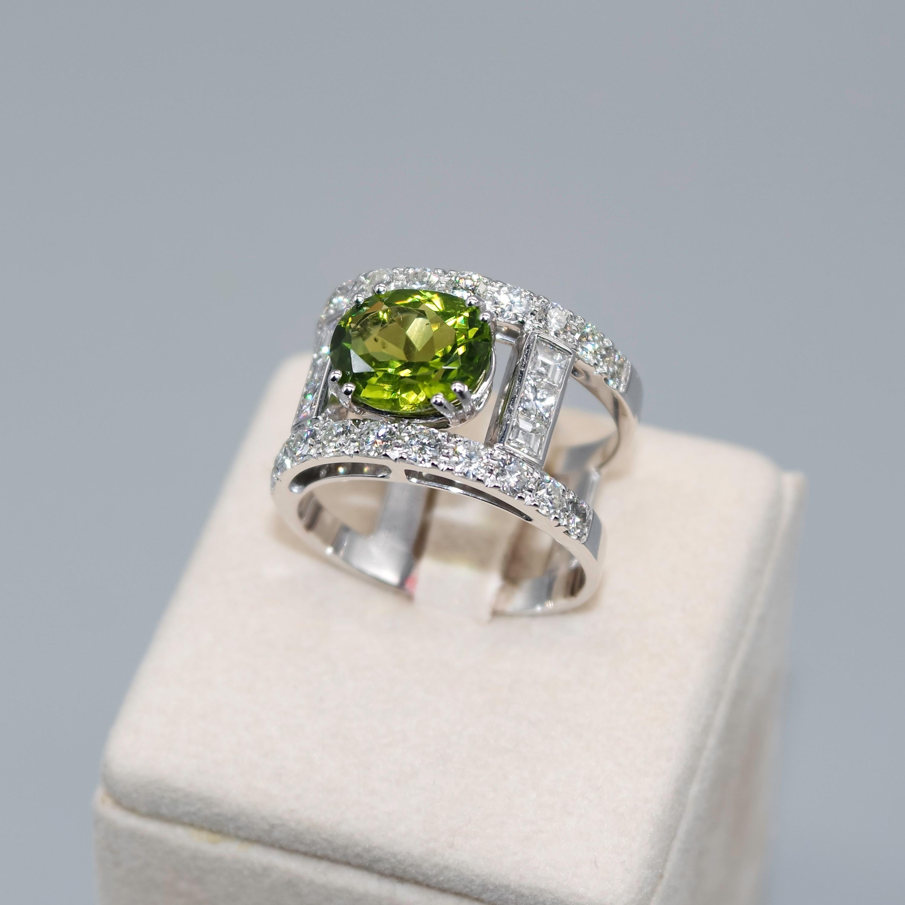 This spectacular cocktail ring is magnified by this light intense transparent yellowish green  oval faceted peridot of 3.69 carats with 18 karat white gold. 
The ring construction enhances the beauty and unicity of the central stone, well set with 8