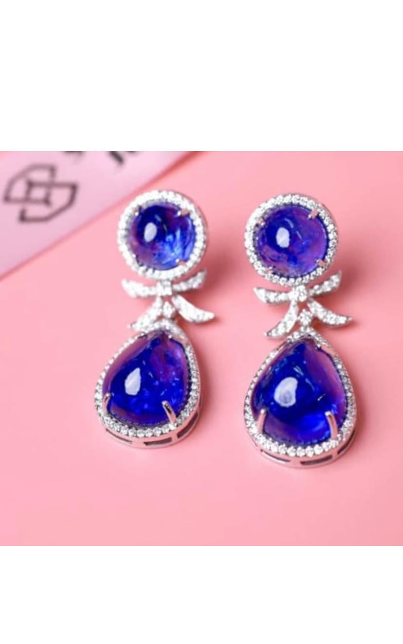 An exquisite Tanzanites and Diamonds earrings, in a contemporary design, so elegant and refined style. 
Elevate your timeless of beauty and add a touch of color on your look.
Stunning earrings come in 18k gold with a 4 pieces of lustrous Tanzanites