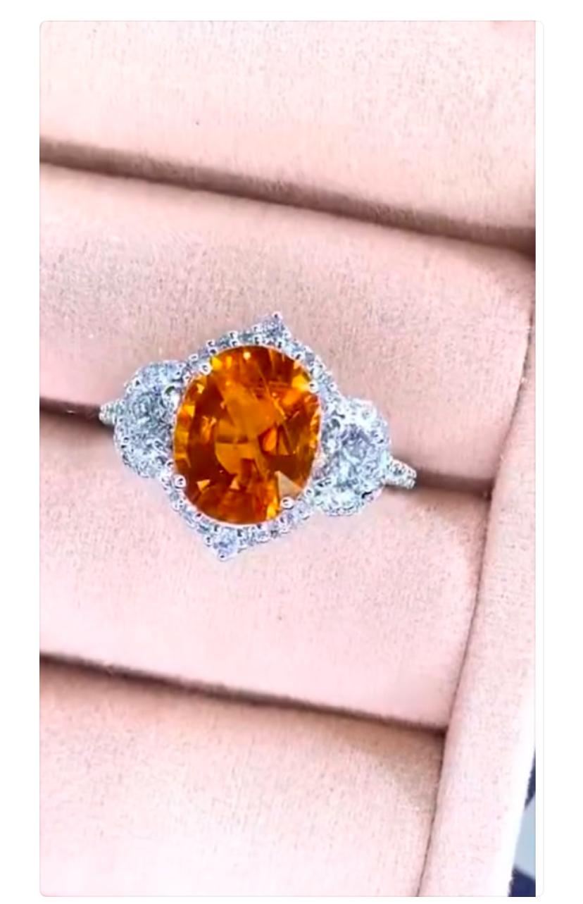 An exquisite Orange Sapphire and Diamonds ring, in elegant modern design, so refined and sophisticated style.
Elevate your beauty and adds a touch of charm and color on your look. 
Magnificent ring come in 18k gold with a lustrous Orange Sapphire of