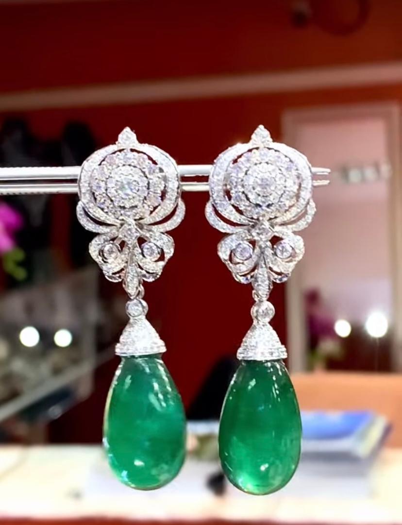 A pair of exquisite earrings boast a classic design that exude timeless elegance.
The Emeralds , with their verdant green hue , captivate the eye with their vibrant brilliance . Nestled amongst  the emeralds are glistering diamonds , which add a