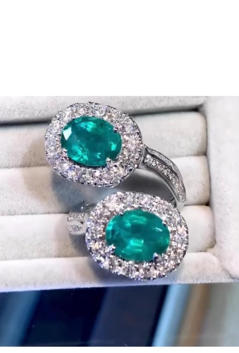 A stunning ring , absolutely beautiful , contrary design, so gorgeous and sophisticated, a very refined style, by Italian jewelry designer,
Ring come in 18K gold with 2 pieces of Natural Zambian Emeralds, extra fine quality, exceptional color , CEO