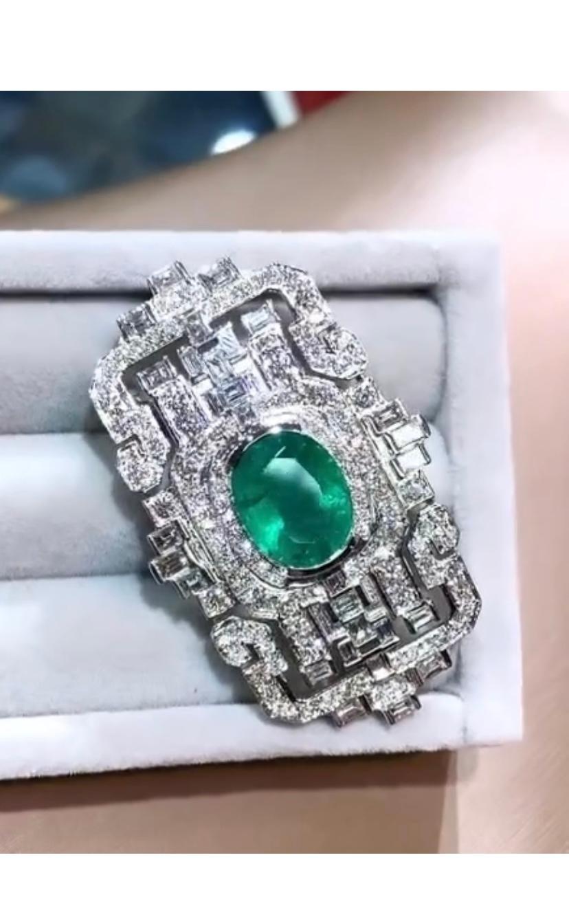 Die Art Decò Brosche mit Smaragd und Diamanten ist ein Meisterwerk der Handwerkskunst. Das verschlungene Design mit zarten Smaragden und funkelnden Diamanten ist wirklich atemberaubend. Die Liebe zum Detail und die Präzision bei der Herstellung