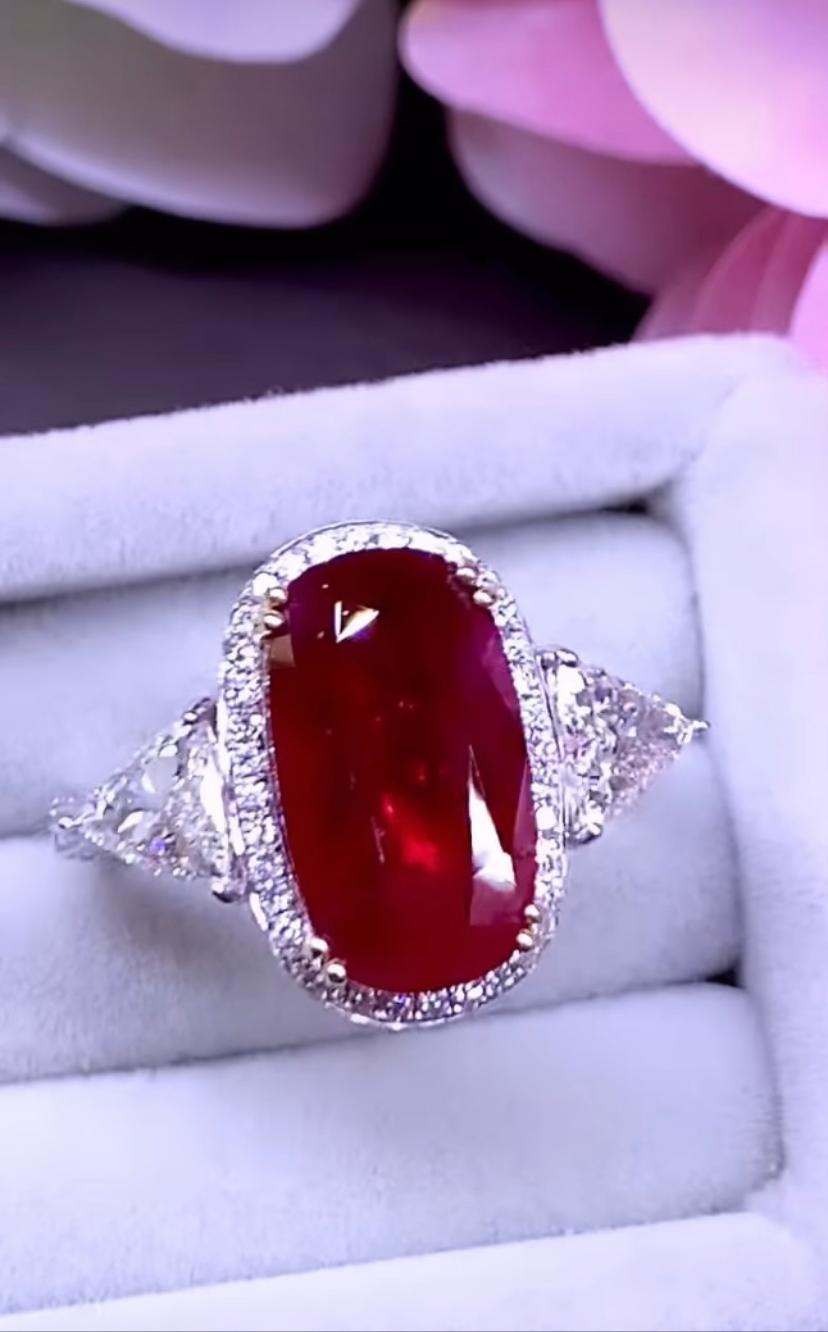 An exquisite contemporary design, so chic and elegant, perfect for important events.
Ring come in 18k gold with a natural Ruby from Mozambique, spectacular color, extra fine quality, oval cut, big face, 5.56 carats, and two natural diamonds in