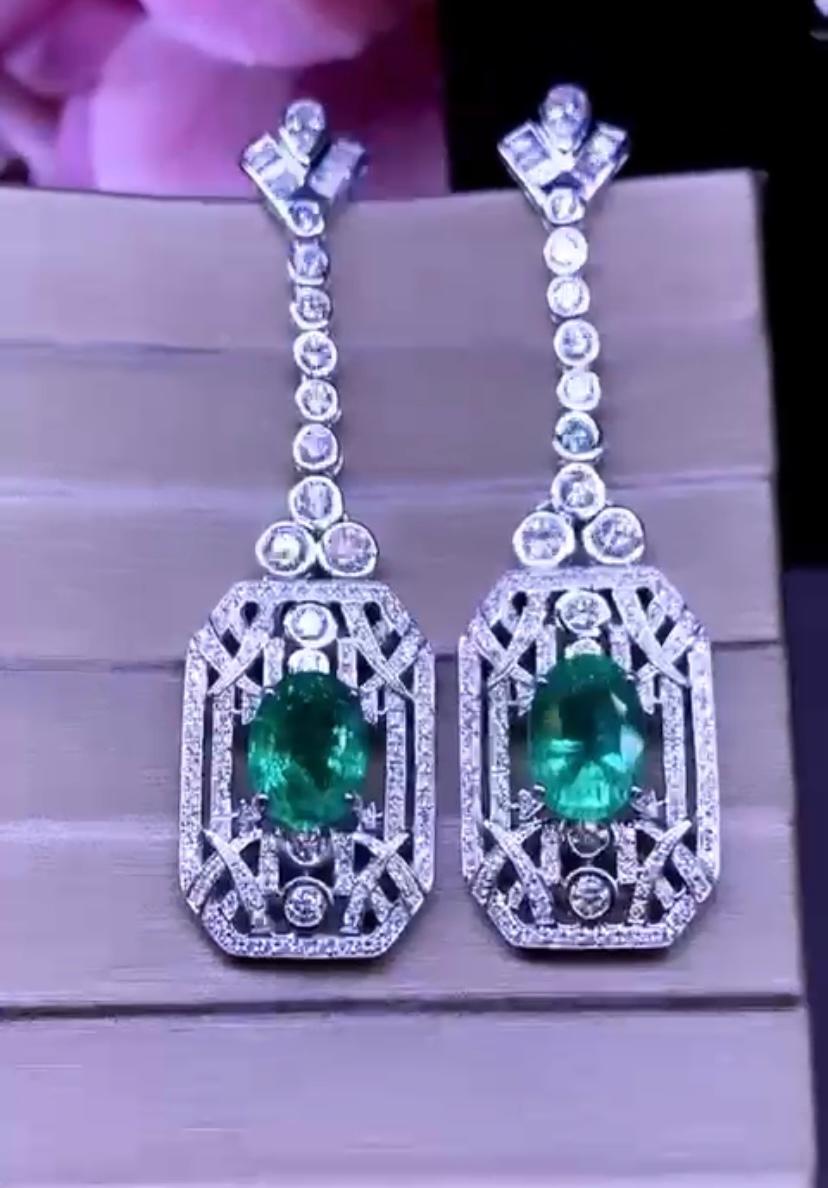 A luxurious and refined Art Deco design, a very stunning style.
Earrings come in 18k gold with 2 pieces of natural Zambian Emeralds  in oval cut, fine quality  6.17 carats , amazing color, and 276 pieces of natural diamonds in round 3.23 carats, F