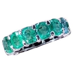 AIG Certified 6.40 Carat Zambian Emeralds  18K Gold Eternity Band