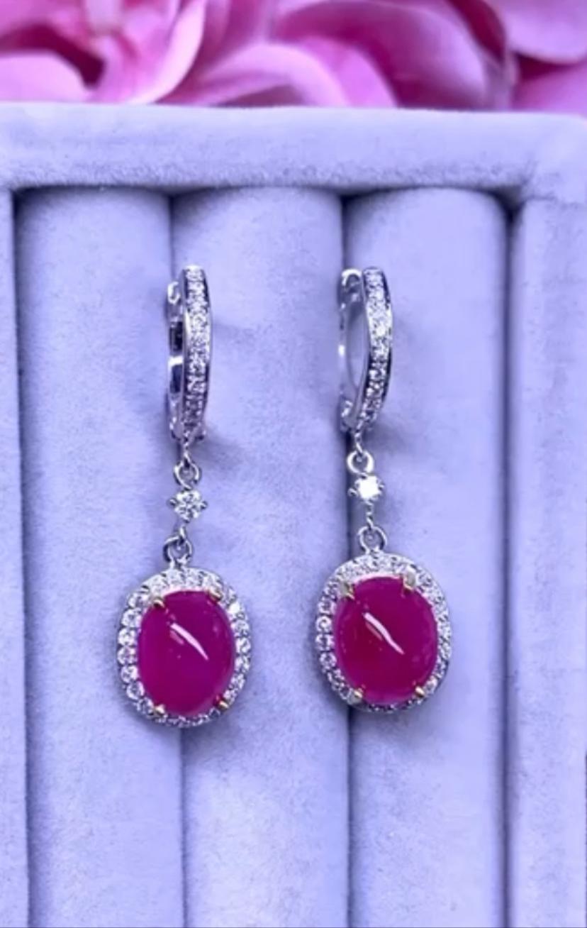 An elegant and chic style for this adorable earrings in 18k gold with two pieces of natural Burma rubies, in perfect oval cabochon cut, of 9,90 carats,fine quality , and 64 pieces of natural round brilliant cut diamonds of 0,66 carats, F color and
