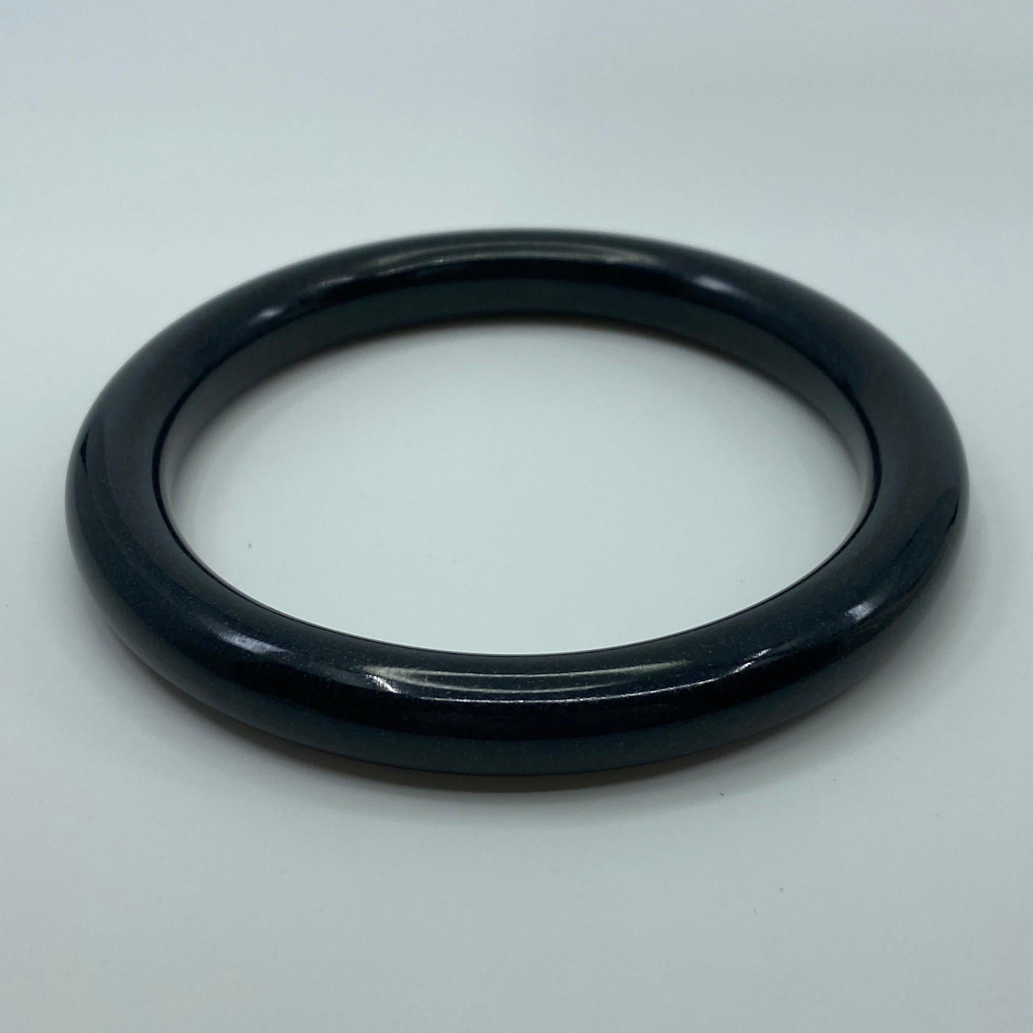 AIG Certified Natural Black Jade Bangle Bracelet 53.52g

Has a beautiful rich black colour with an excellent polish and lustre with no cracks or chips.

This is a treated jade bracelet, as to be expected of such a large piece in this price