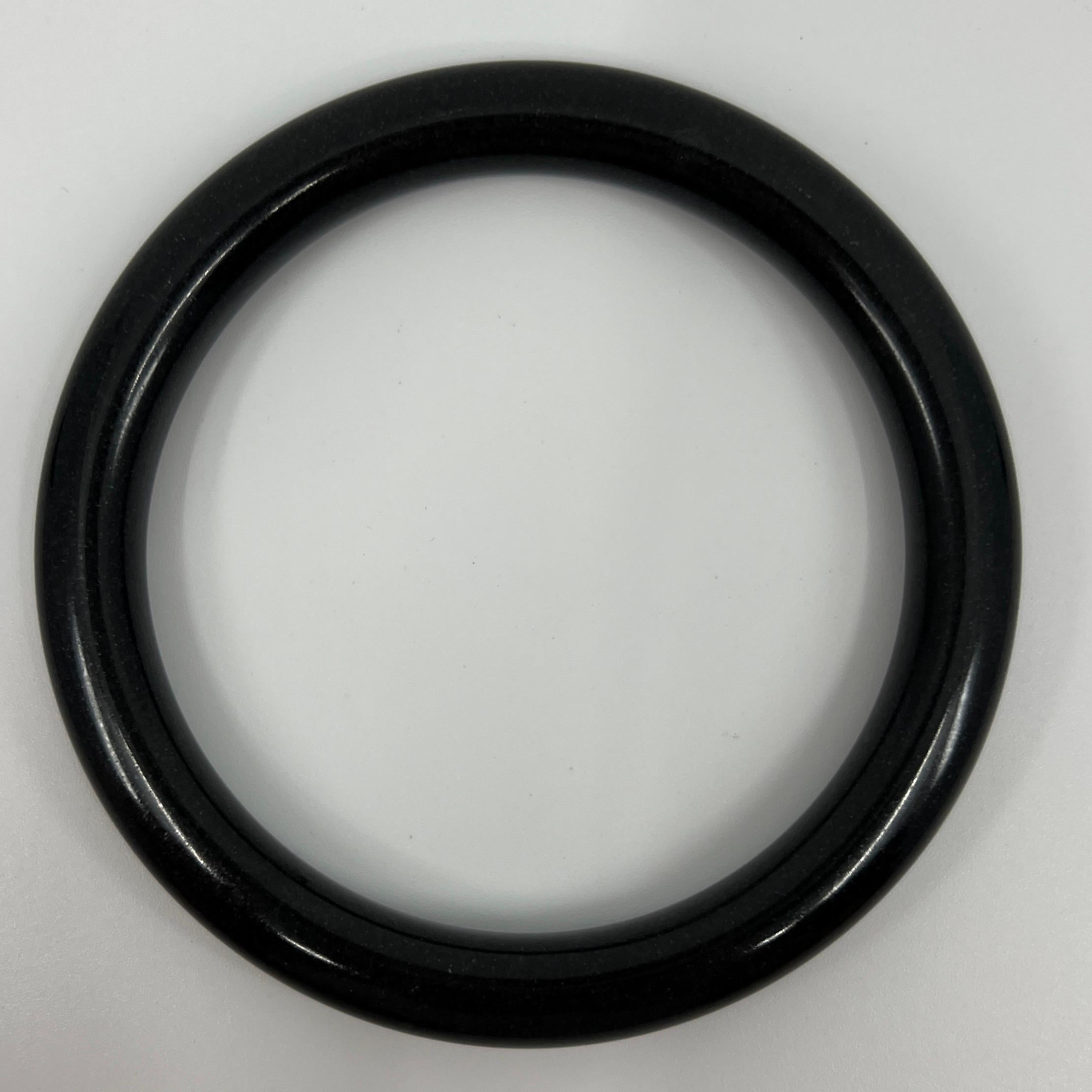 AIG Certified Natural Black Jade Bangle Bracelet 53.1g

Has a beautiful rich black colour with an excellent polish and lustre with no cracks or chips.

This is a treated jade bracelet, as to be expected of such a large piece in this price