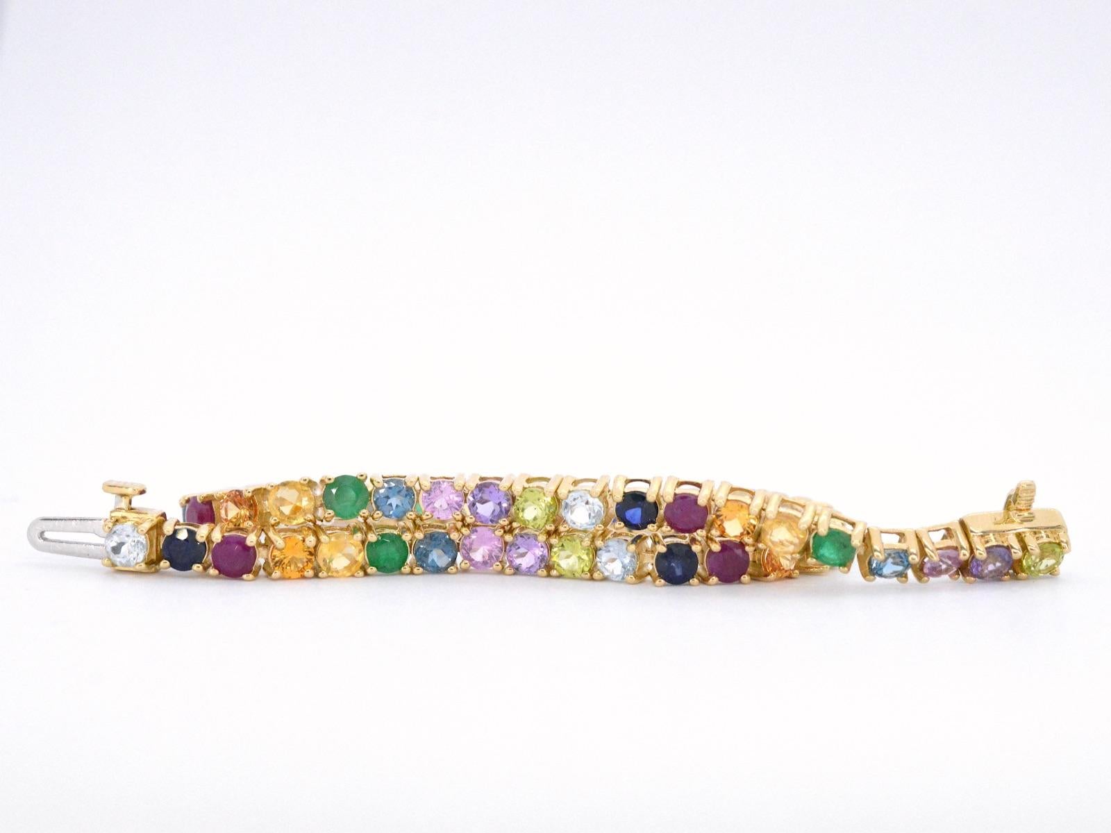 This is a beautiful bracelet that features natural gemstones cut in round facetted shapes. The bracelet is made of 14 karat gold and weighs 10.30 grams. It has a length of 18 cm and is hallmarked as such.

The gemstones used in this bracelet weigh a