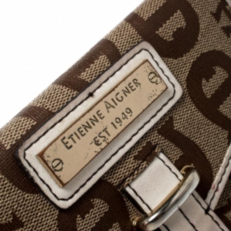 Questo portafoglio compatto di Aigner è realizzato con la tipica tela Coates. È progettato con più slot per carte di credito e scomparti per i contanti. Rifinito con una placca incisa con il logo e una chiusura a libro sul davanti, questo