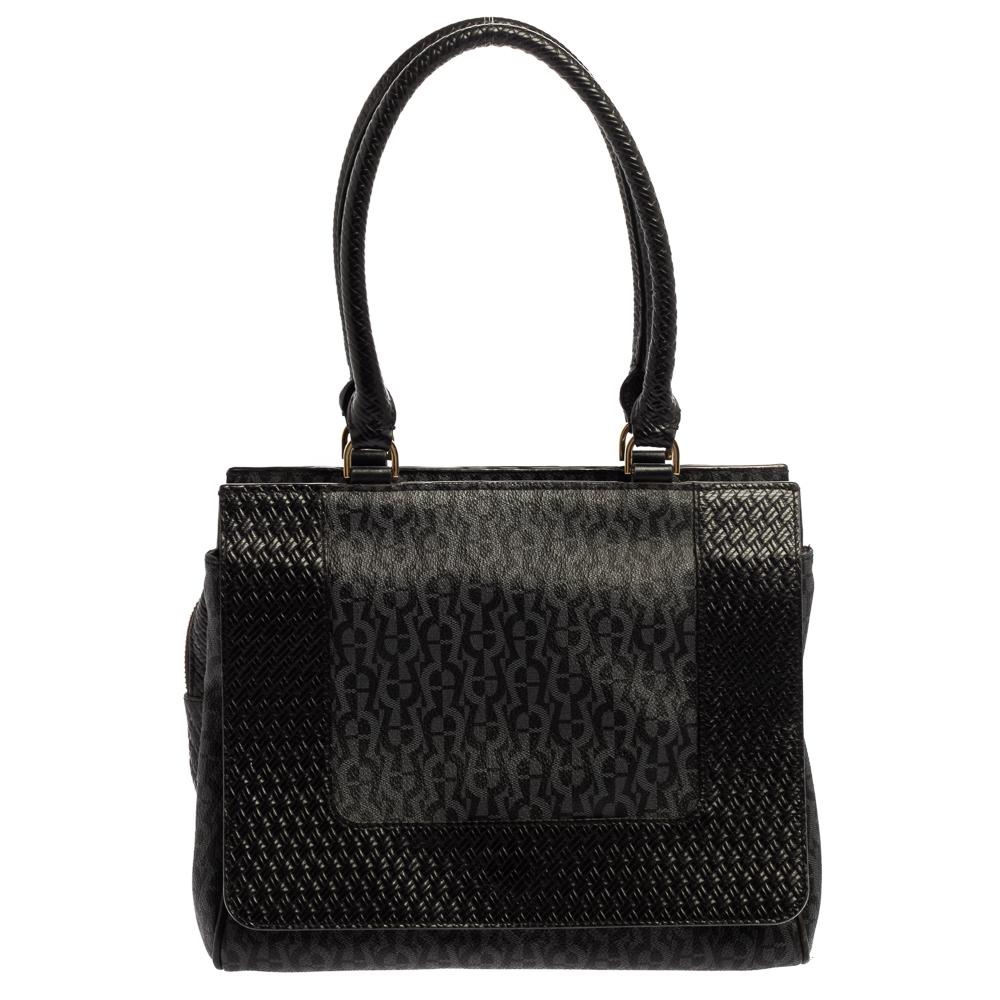 From the house of Aigner, this handbag is an excellent blend of elegance and style. This satchel has been crafted from canvas as well as leather in a shade of black. It has dual handles, logo detailing, gold-tone hardware, and a spacious