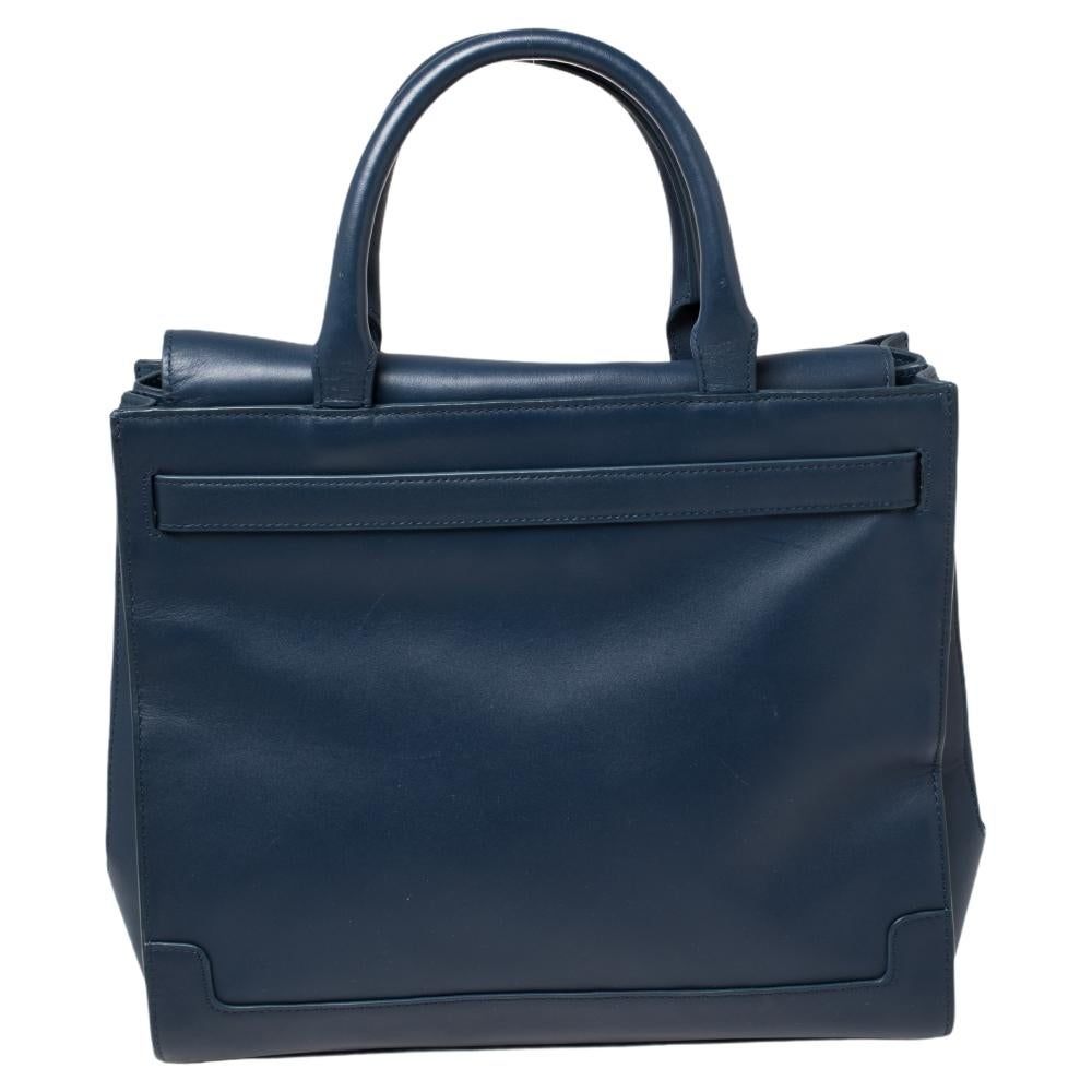 This tote from Aigner is crafted from blue leather. The bag features a turn-lock and the brand logo in gold-tone at the front, two top handles, and a well-sized fabric interior. This creation is easy to carry on any day.

Includes: Authenticity