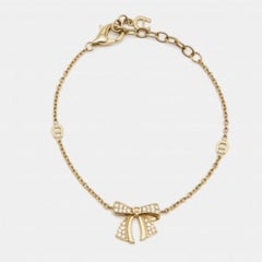 Aigner - Bracelet en cristaux avec nœud - tons or