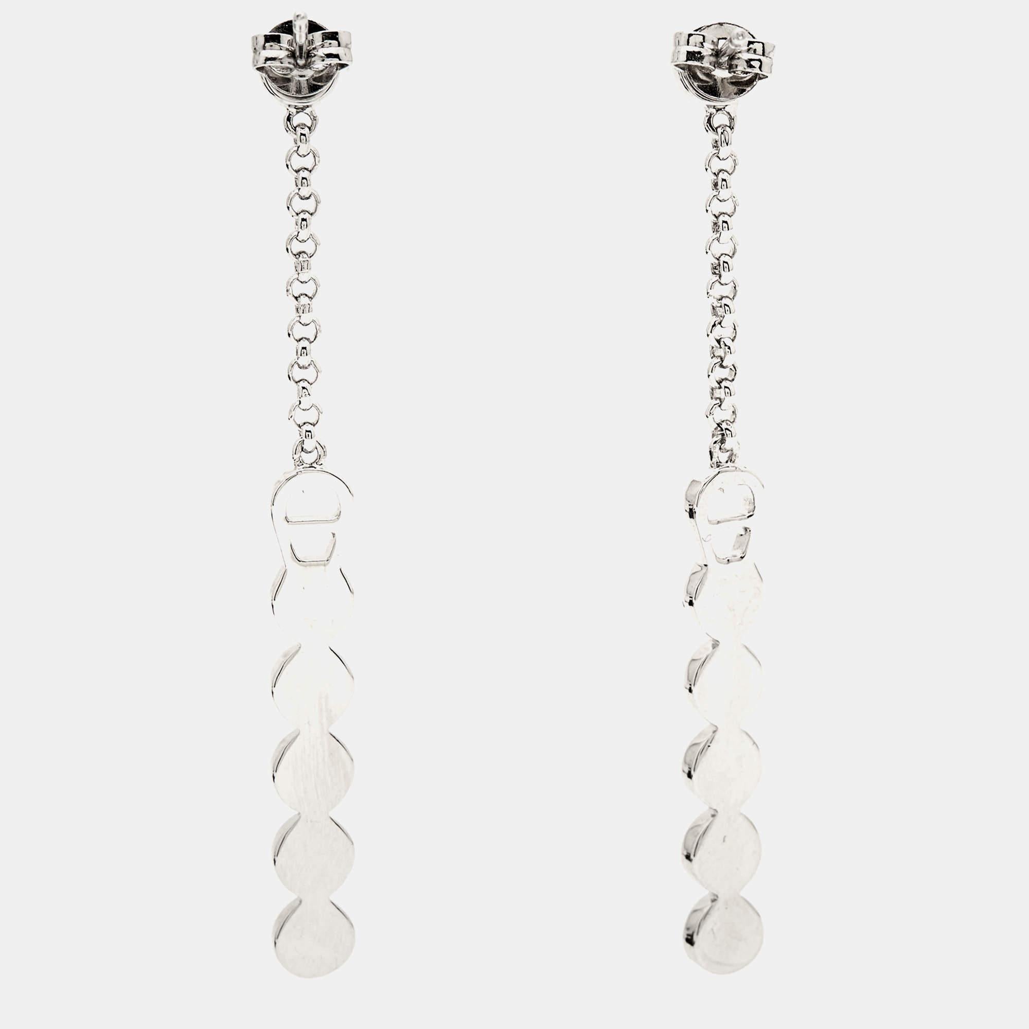 Easy to wear, beautiful, and stylish, these Aigner earrings are perfect to wear with your casual everyday edit as well as party looks. Constructed in silver-tone metal, this pair is beautified with crystals.

Includes: Original Dustbag