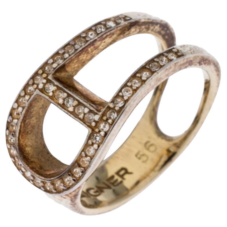 Boasting of an understated yet elegant look, this Aigner ring is crafted from a gold-tone body with a curved logo at the top. It comes with beautiful crystal embellishments that lend it a glamorous look. Wear it for evening outings for a smart and