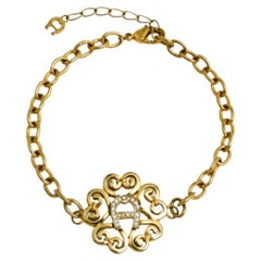 Aigner Gold Tone Crystal Logo Bracelet