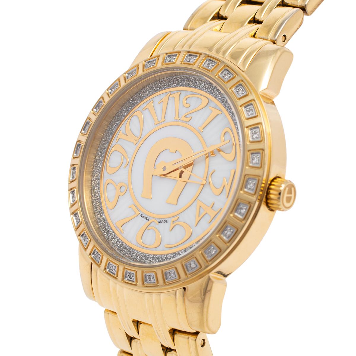 Aigner is considered the first voguish brand for stylish living from Germany. This gold-plated stainless steel women's wristwatch by Aigner is a fashionable example of the aforementioned. The watch features a fancy round bezel with embellishments