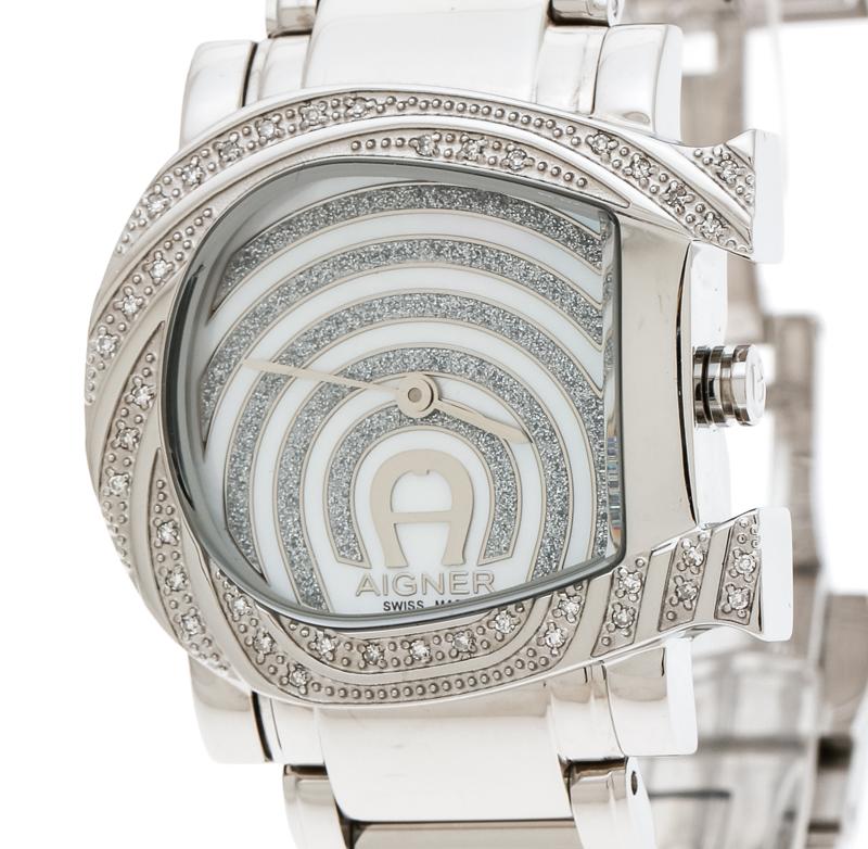 Aigner leaves us awestruck with this Genua Due wristwatch and makes a perfect gift for the lady of substance! The namesake brand is known for its richly-decorated dials. This 31 mm watch has a mother of pearl dial detailed with silver hands for