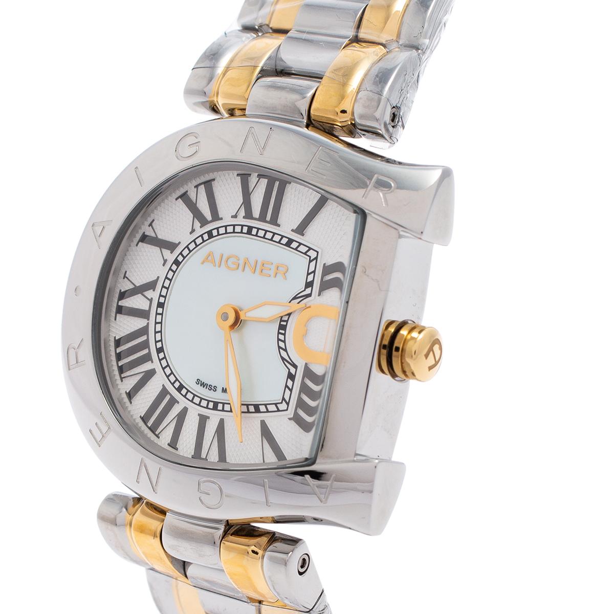 This Aigner wristwatch is a statement of luxury. This watch belongs to the brand's Arco collection. Constructed in two-tone stainless steel, this watch features a mother of pearl dial set with hour markers and a logo-shaped bezel. It has a quartz
