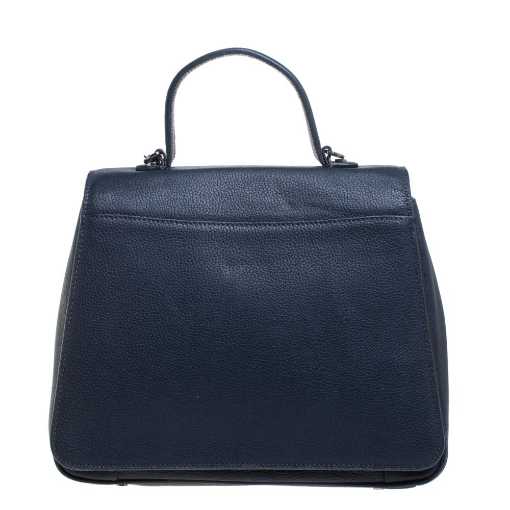 You will enjoy parading this bag from Aigner. It comes made from navy blue leather and features a single top handle and a shoulder strap. It is equipped with a fabric-lined interior meant to hold all your daily essentials with ease.

Includes: Logo