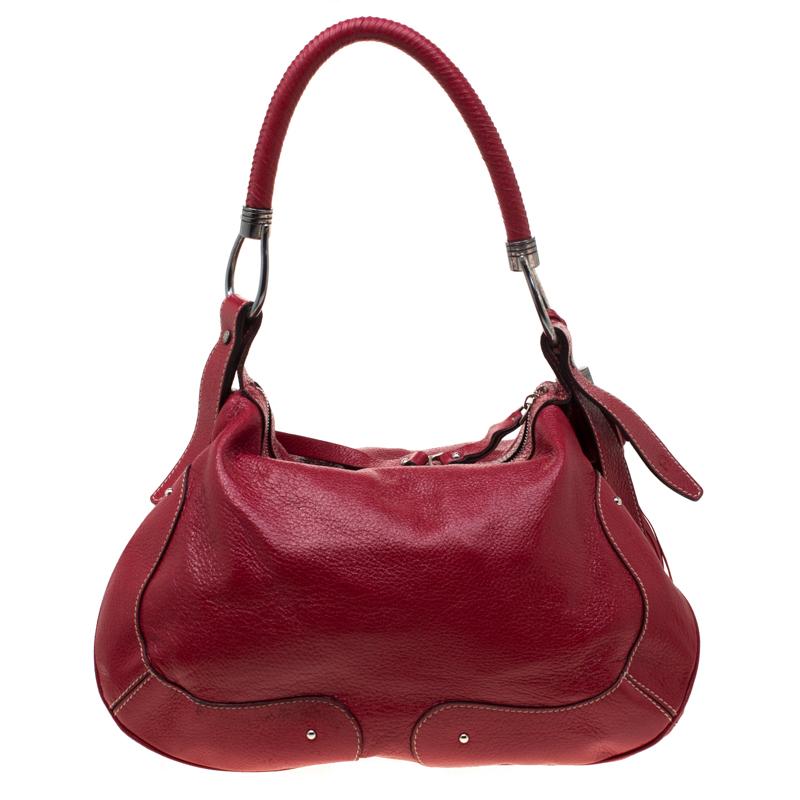 Aigner showcases a masterfully designed handbag from its collection of accessories. Crafted from fancy leather, this would let you flaunt the latest fashion. It has a fabric lined interior offering enough storage for everyday essentials. Red in