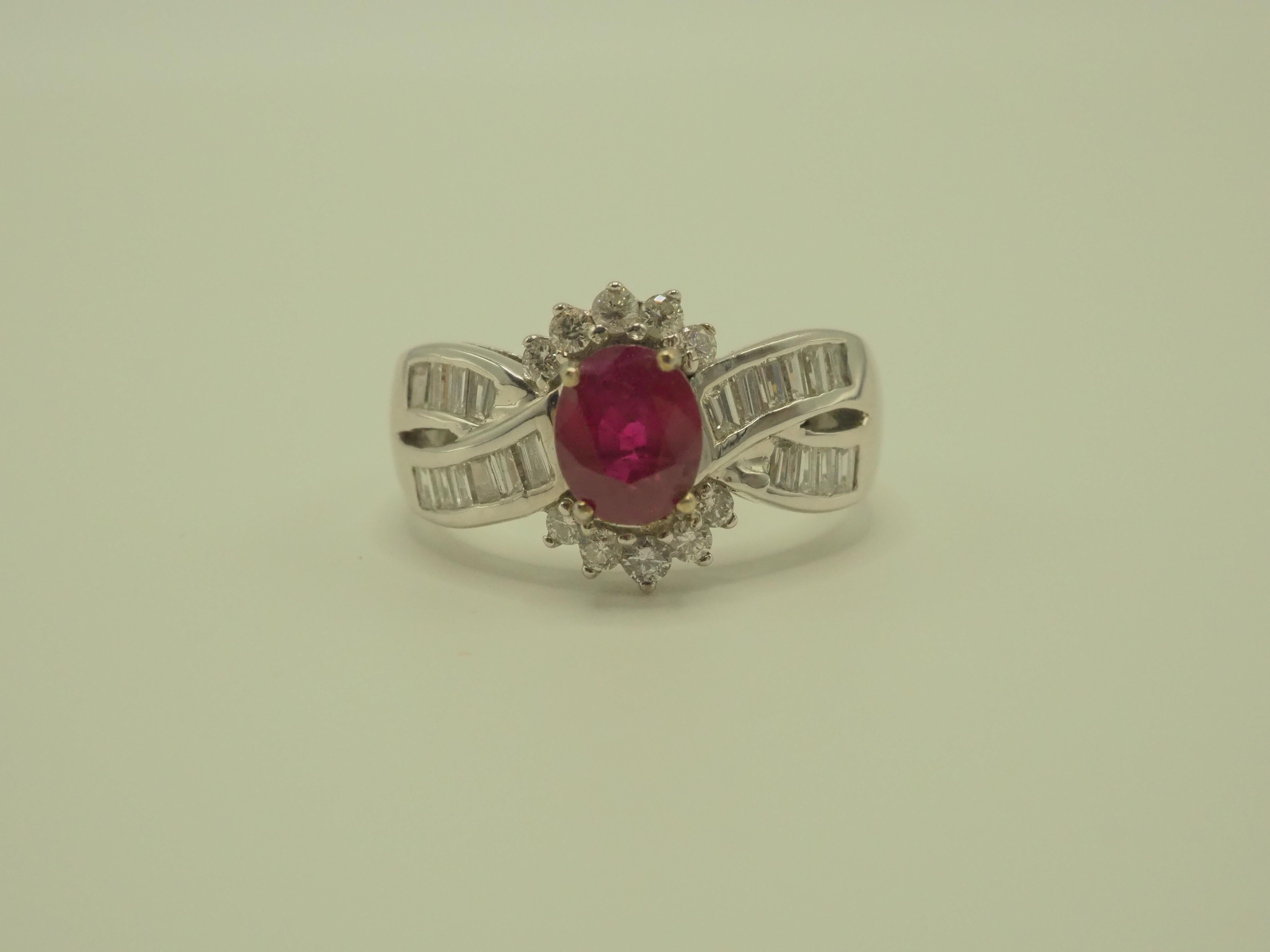 Beautiful and peak unique cocktail ring boasts a lovely oval ruby at the center! The ruby is an oval cut and is bright with high saturation of color and with natural inclusions. There are numerous tapered baguette and round melee diamonds accenting