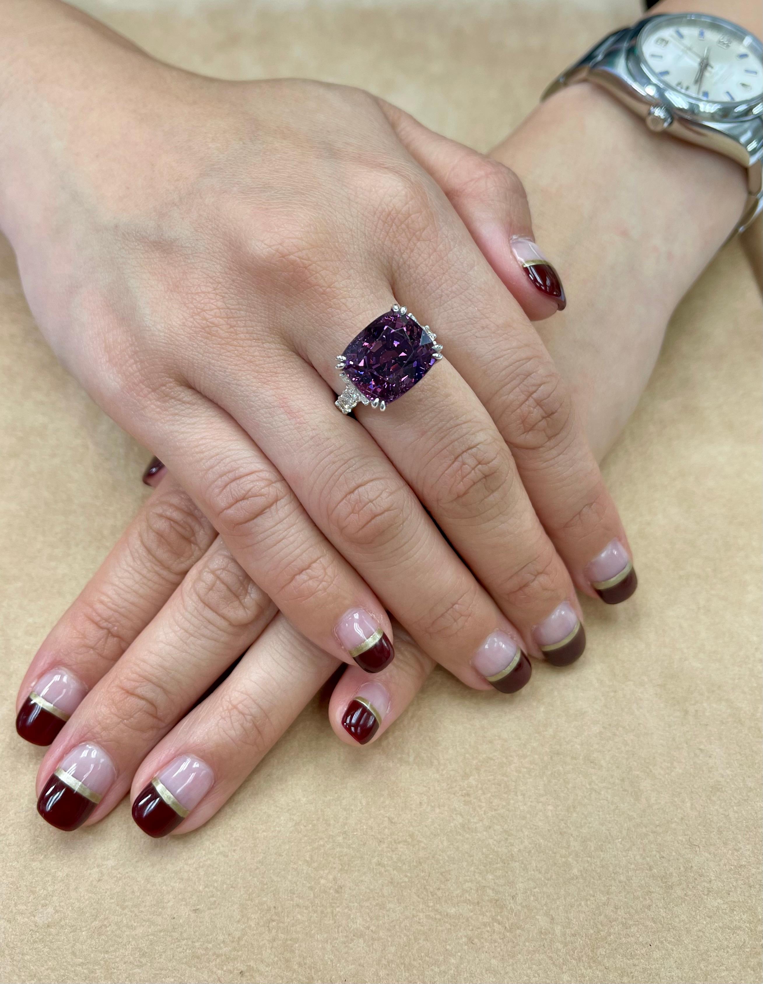 Here is an oversized natural Spinel with a strong deep purple color saturation. It is set in 18k white gold and diamonds. 6 round and 4 marquis diamonds totaling 1 carat. Average size of each diamond is about 0.10 Cts each. The purple Spinel is cut