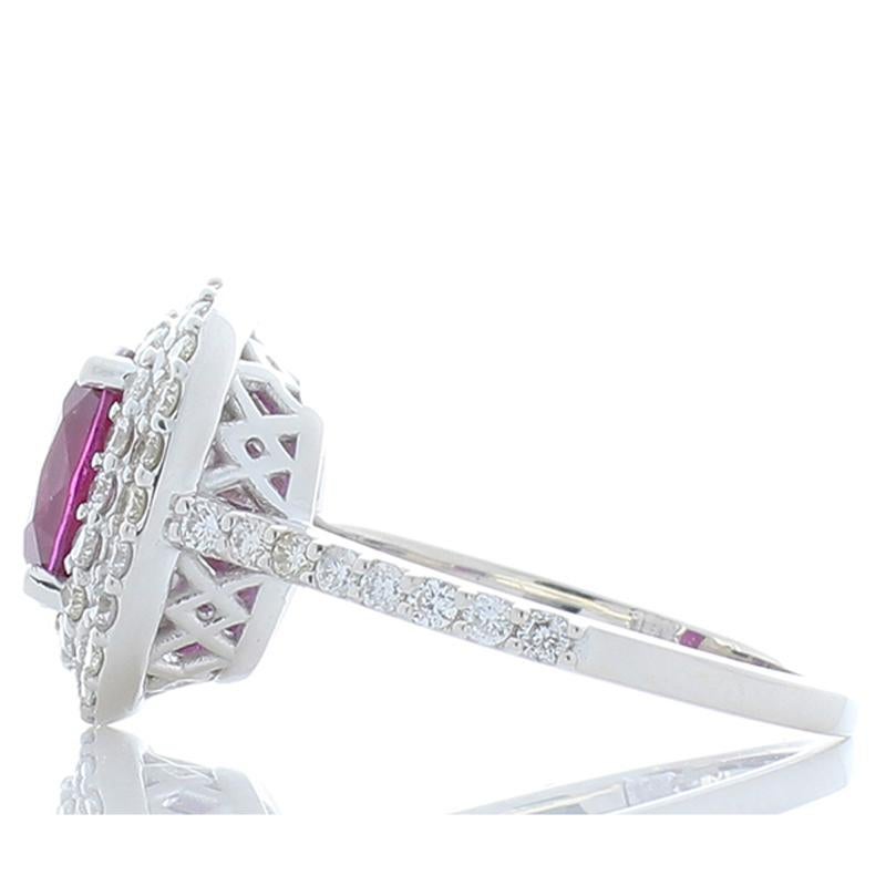 A AIGS certified unheated natural pink sapphire is set in the center of this ring. The 2.56 carat vivid purplish-pink gemstone is vibrant. Unheated makes it rare; its luster and transparency are excellent. The gem source is Sri Lanka. Two sparkling