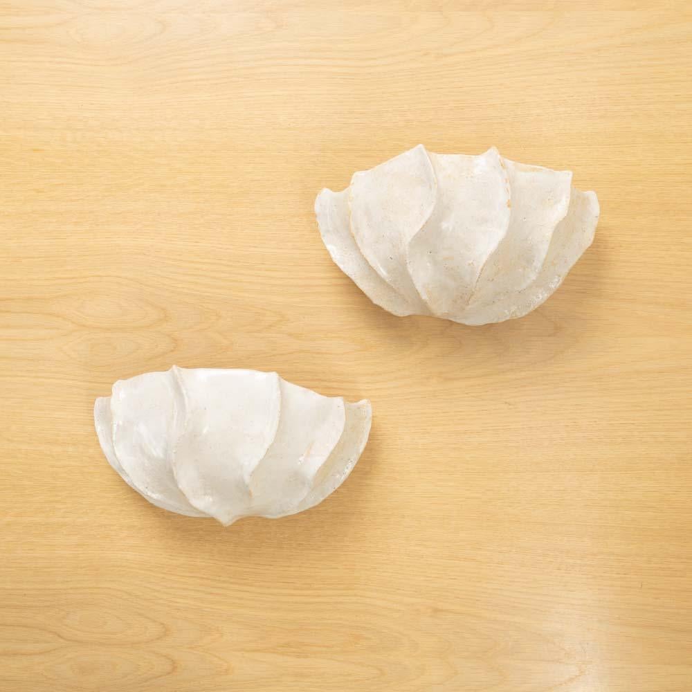 Glazed sculptural sconce by Lucia Mondadori Ceramiques. Lucia Mondadori is a Brazilian ceramic artist based in Paris. Her sculptural work explores the aesthetic interplay between the organic and the symbolic. In her work, she investigates and