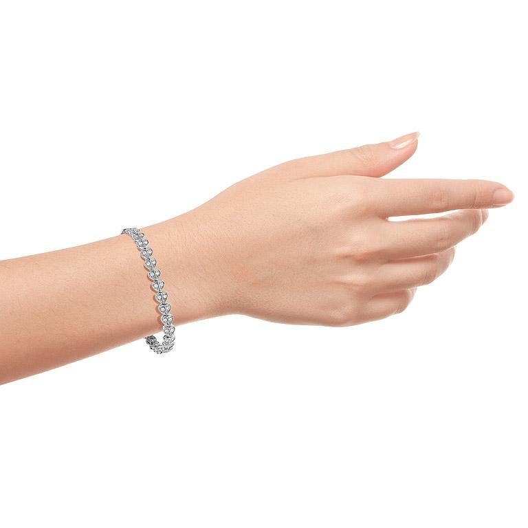 This delicate heart-shaped tennis bracelet is a fun and modern twist to the classic tennis bracelets.

Bracelet Information
Metal: 14K White Gold
Width: 9 mm.
Length: 187 mm.
Weight: 18.7 g. (approx. in total)
Clasp: Push Clasp

Gemstones 
Type: