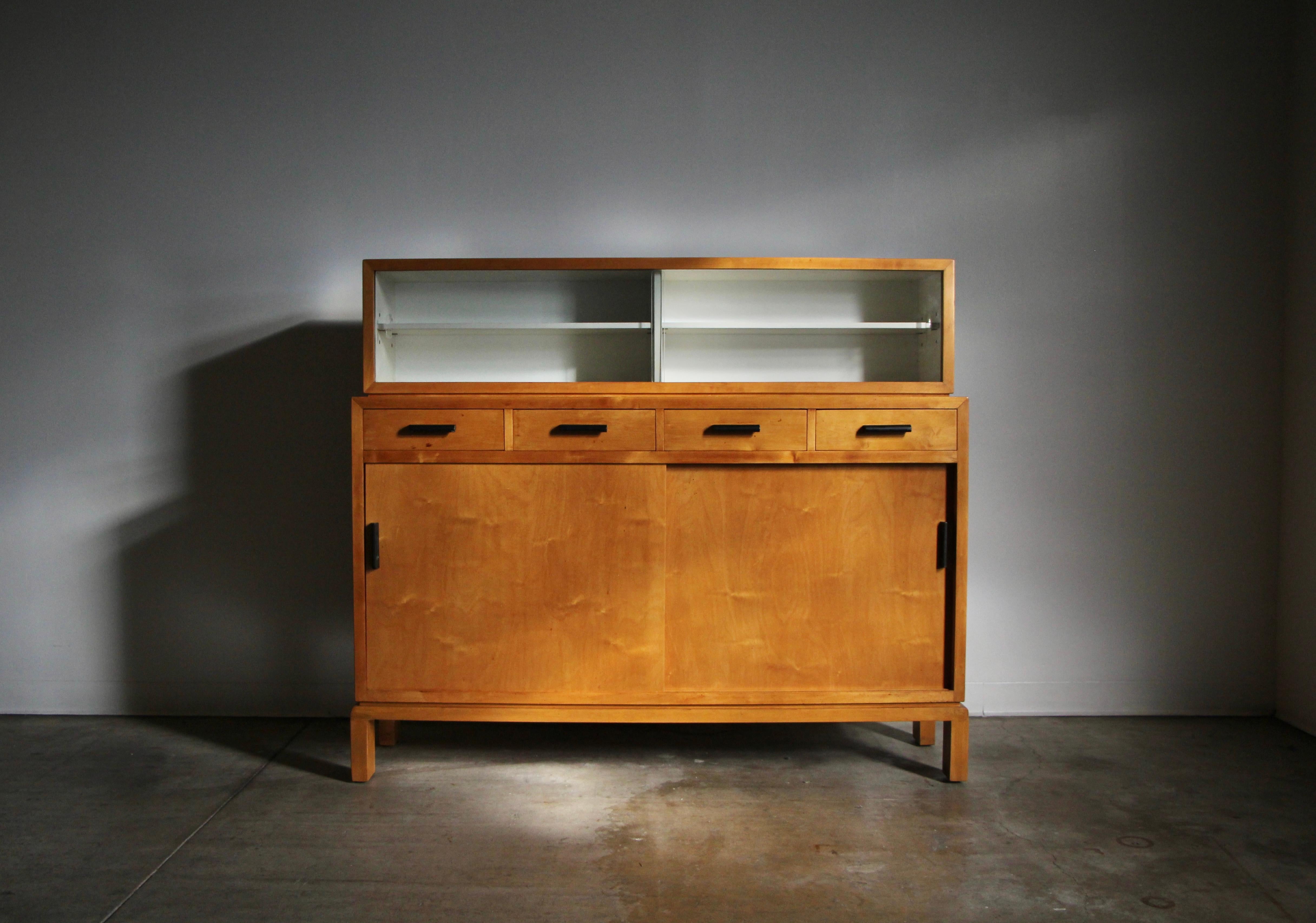 Aino Aalto rare two-section cabinet, Model 810 for Oy Huonekalu-ja Rakennustyötehdas Ab. Cabinet is constructed of birch and birch plywood with original glass sliding doors. Lower section with drawers and double doors. Top portion of cabinet can be