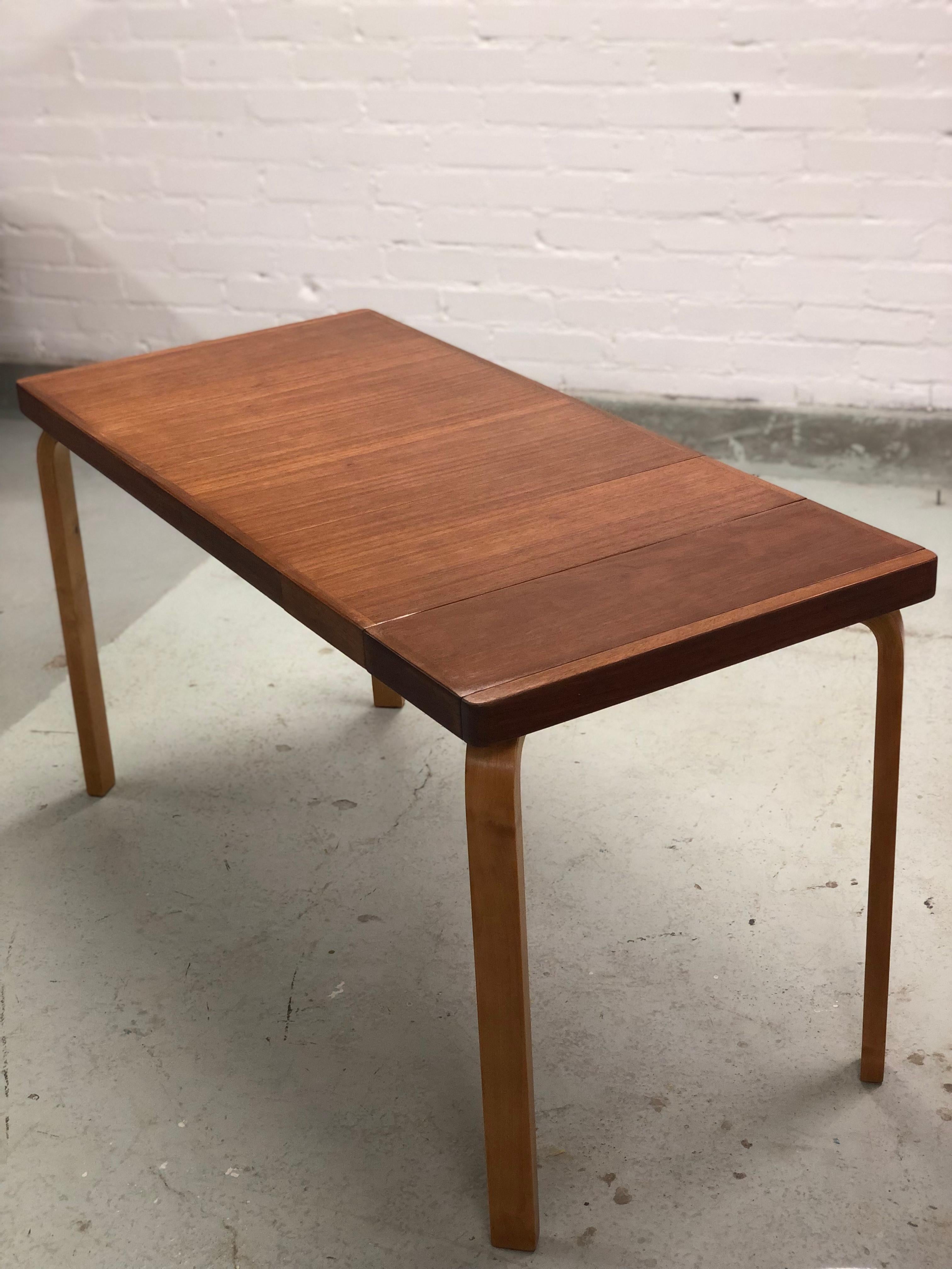Aino Aalto extendable table with a teak top and birch legs. Designed by Aalto and manufactured by Artek in the 1930s. The table is 95cm long but has an opening with two separate 20cm long extensions which can make the table either 115cm or 135cm