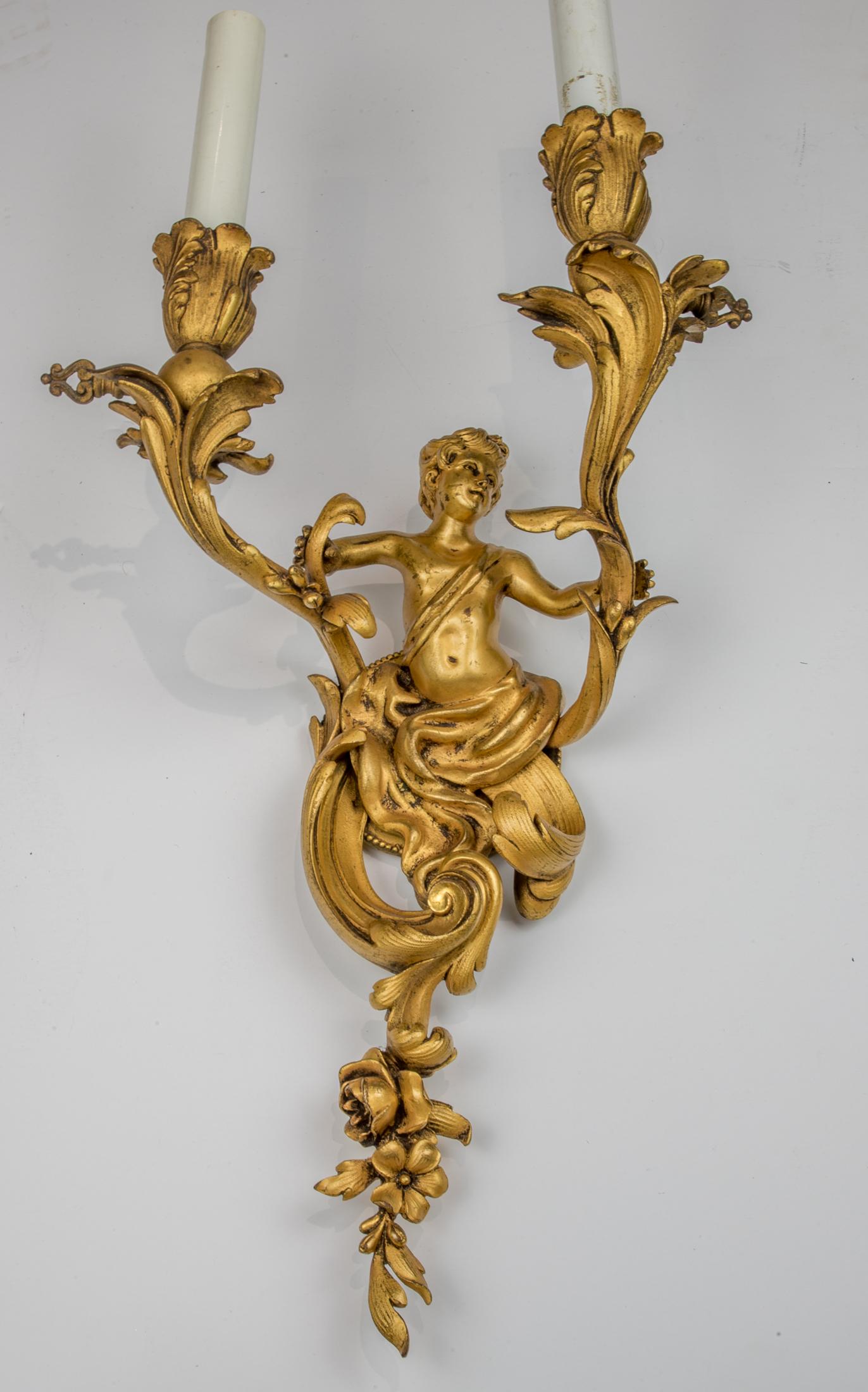 Each circular acanthus leaf decorated backplate issuing a male term holding onto scrolling acanthus leaves ending in bulb-form light sockets.
 
Origin: French
Date: Early 20th century
Dimension: Height 11 x 9 3/4 x 6 1/4 inches.