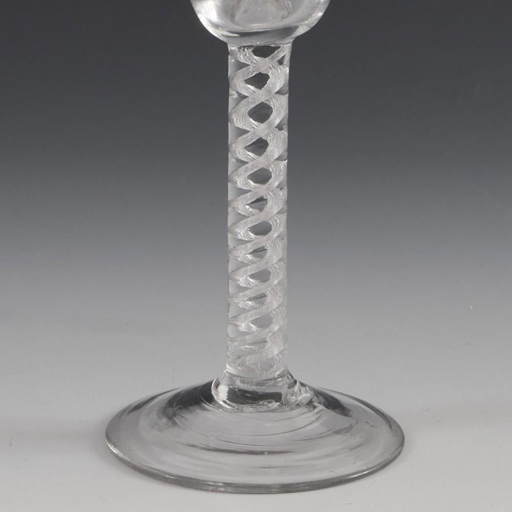 Heading : Air twist stem Georgian wine glass
Period : George II - c1750
Origin : England
Colour : Clear
Bowl : Round funnel
Stem : A pair of multi-ply spiral cables
Foot : Conical
Pontil : Snapped
Glass Type : Lead
Size :  15.1cm height, 5.4cm