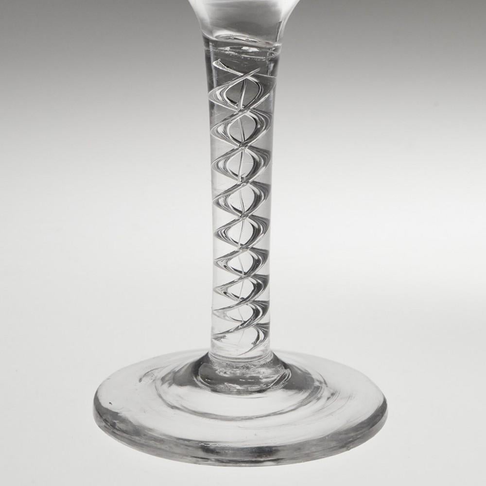 Heading : Air twist stem Georgian wine glass
Period : George II - c1750
Origin : England
Colour : Clear
Bowl : Ogee
Stem : A pair of air tapes outwith a (possibly accidental) fine central thread
Foot : Conical
Pontil : Snapped
Glass Type : Lead
Size